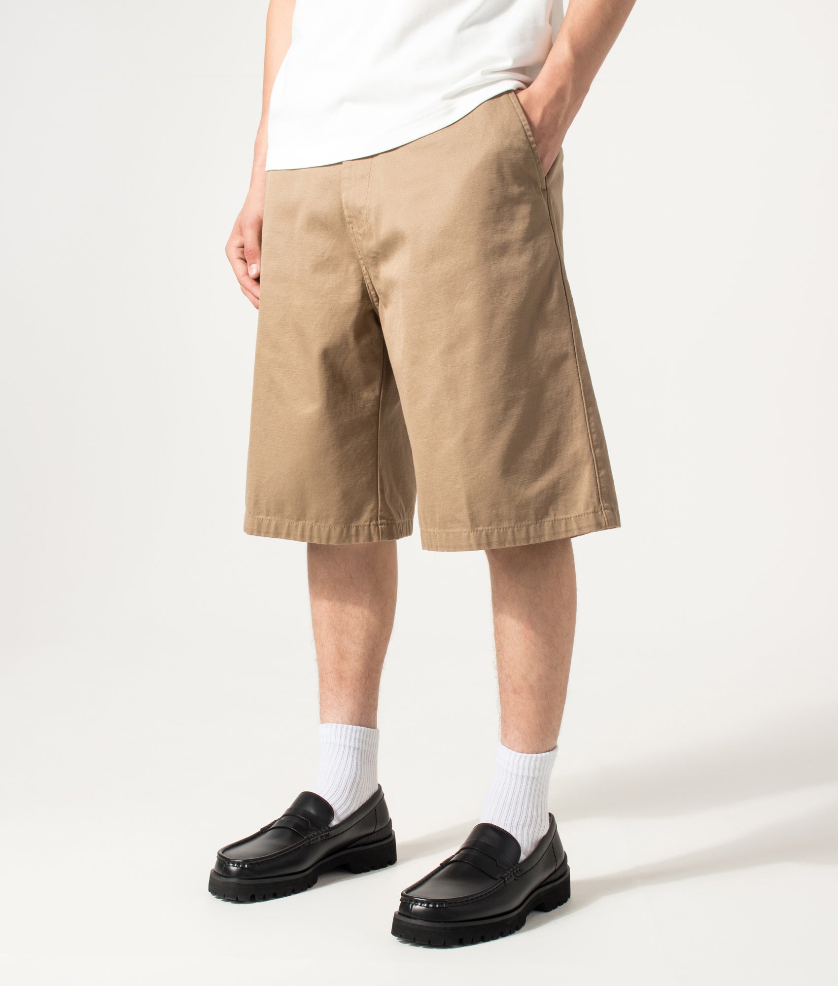 Carhartt WIP Loose Fit Brader Shorts in Rinsed Leather at EQVVS Menswear. Angled model front shot.