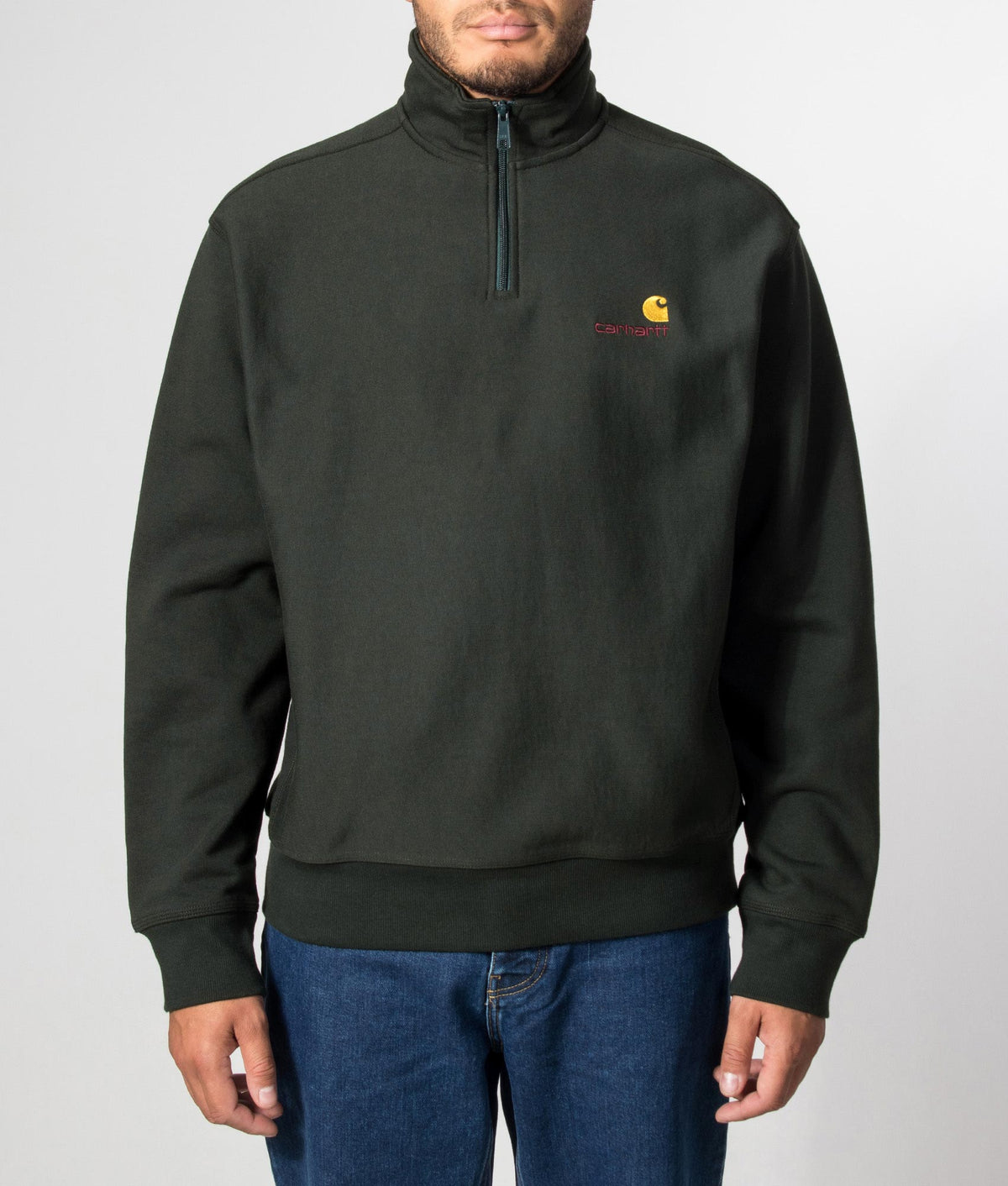 Carhartt WIP Loose Fit Quarter Zip American Script Sweatshirt in Raven at EQVVS Menswear. Model front shot.