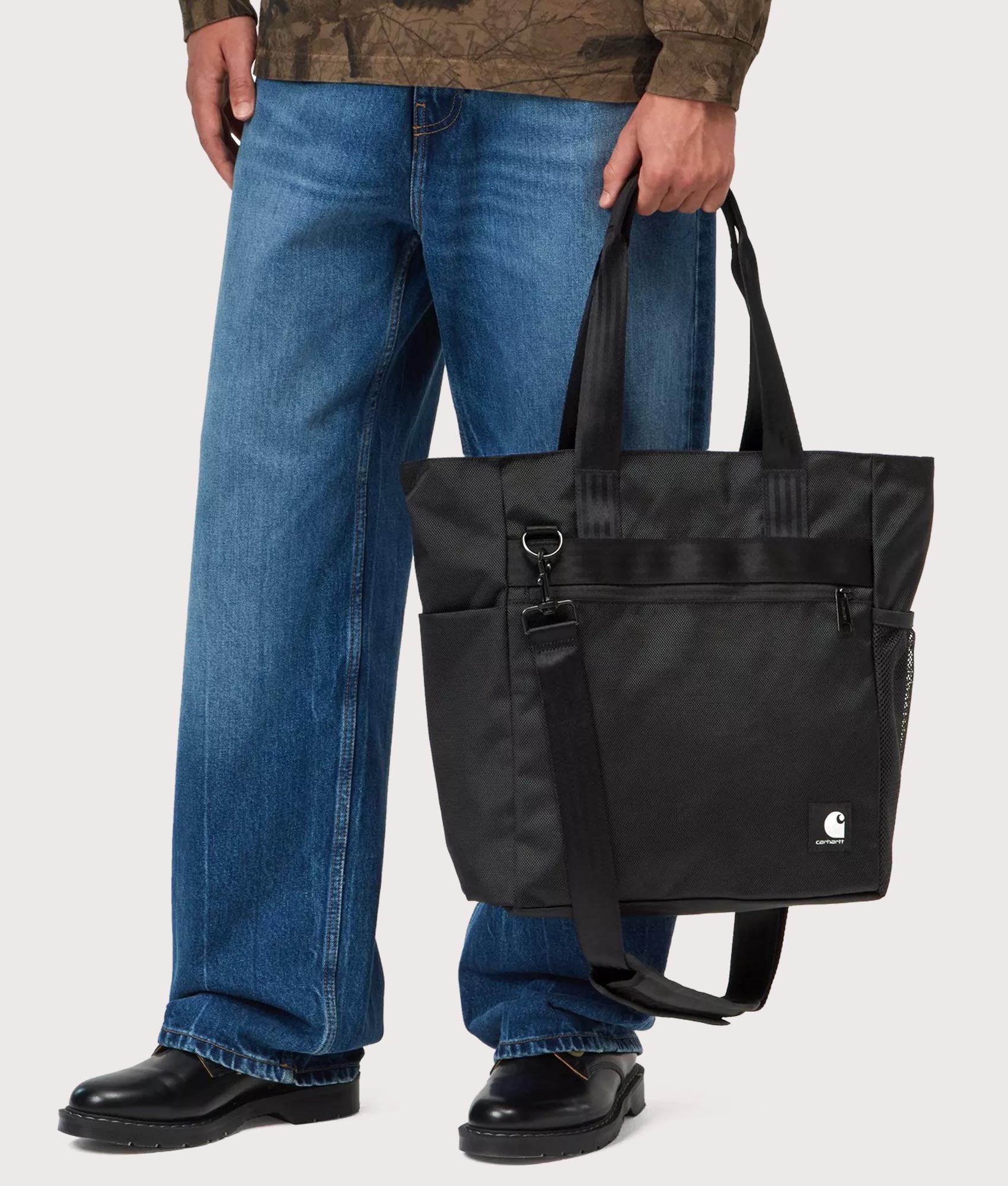 Carhartt WIP Richmond Tote Bag in Black at EQVVS Menswear. Model front shot.