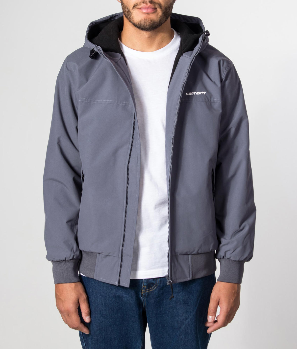 Carhartt WIP Regular Fit Hooded Sail Jacket in Styx and White at EQVVS Menswear. Model front shot.
