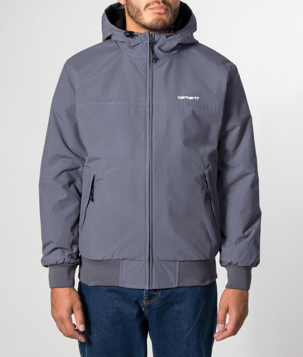 Carhartt WIP Regular Fit Hooded Sail Jacket in Styx and White at EQVVS Menswear. Model front shot.