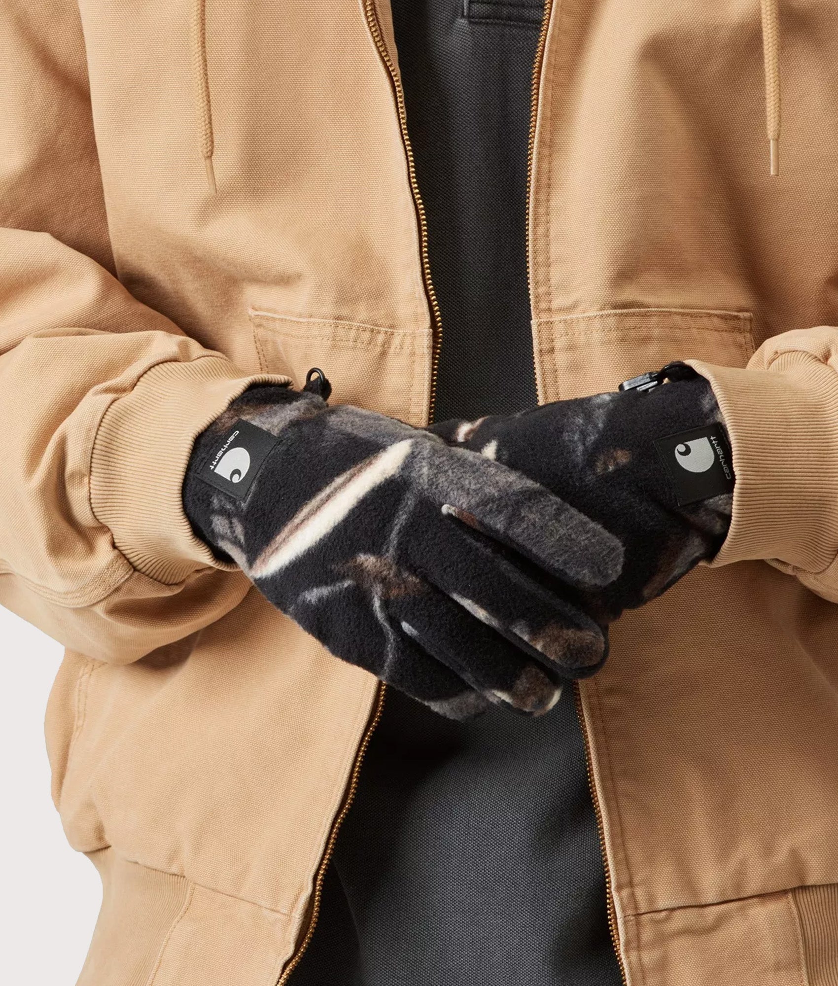 Carhartt WIP Blevin Gloves in Camo Feather Tree and Black at EQVVS Menswear. Model front shot.