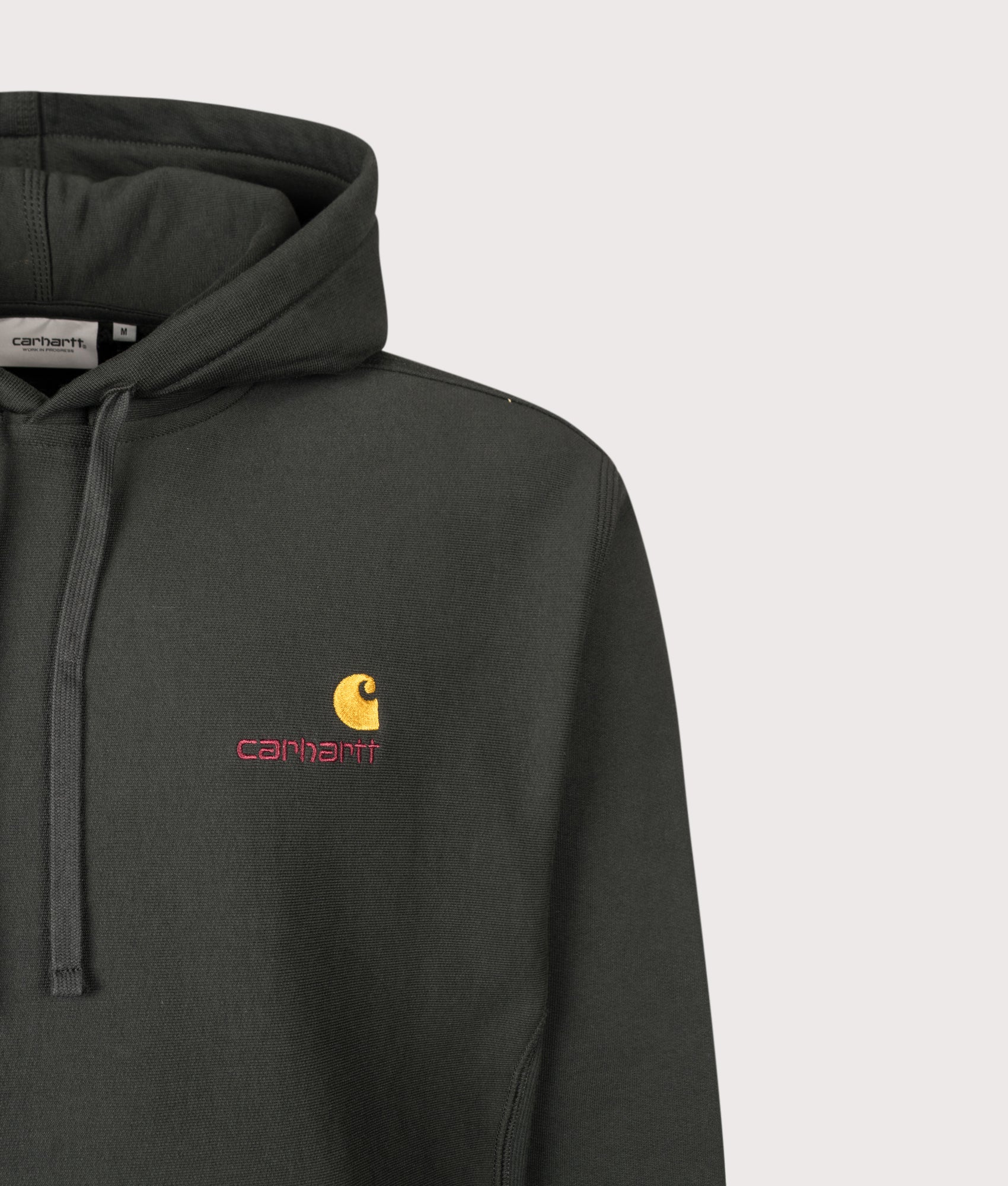 Carhartt WIP Loose Fit American Script Hoodie in Raven at EQVVS Menswear. Detail shot.