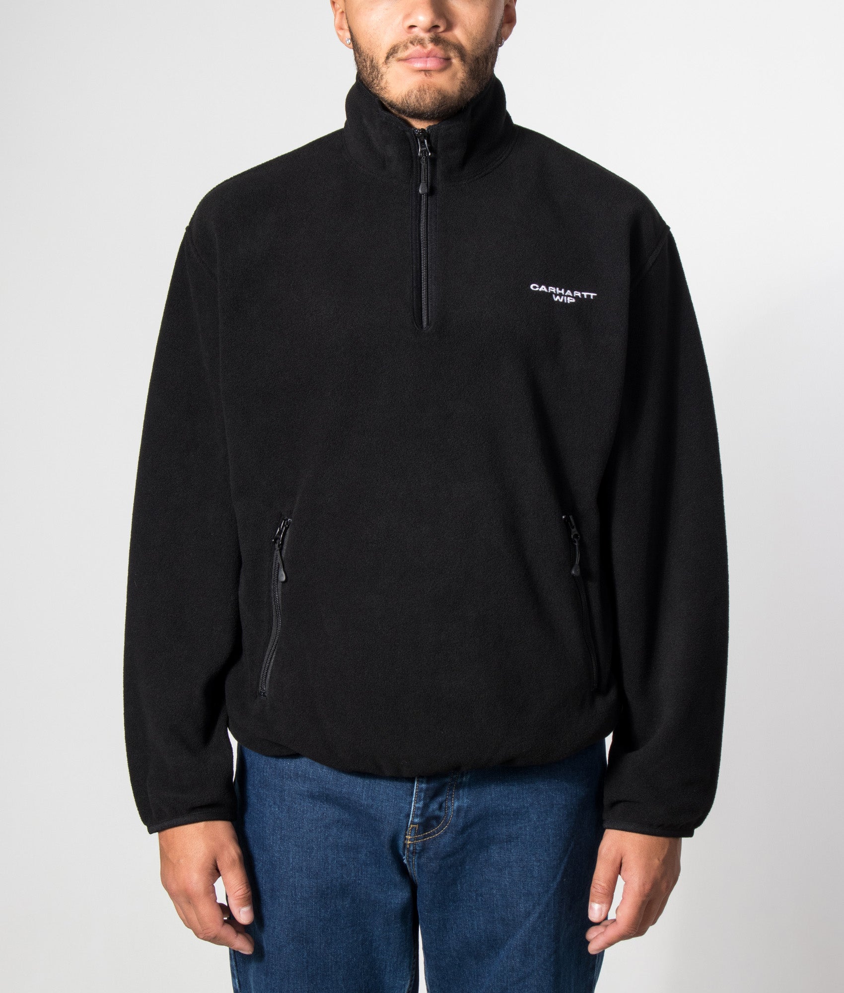Carhartt WIP Balloon Fit Edmore Quarter Zip Fleece Sweatshirt in Black and White at EQVVS Menswear. Model front shot.