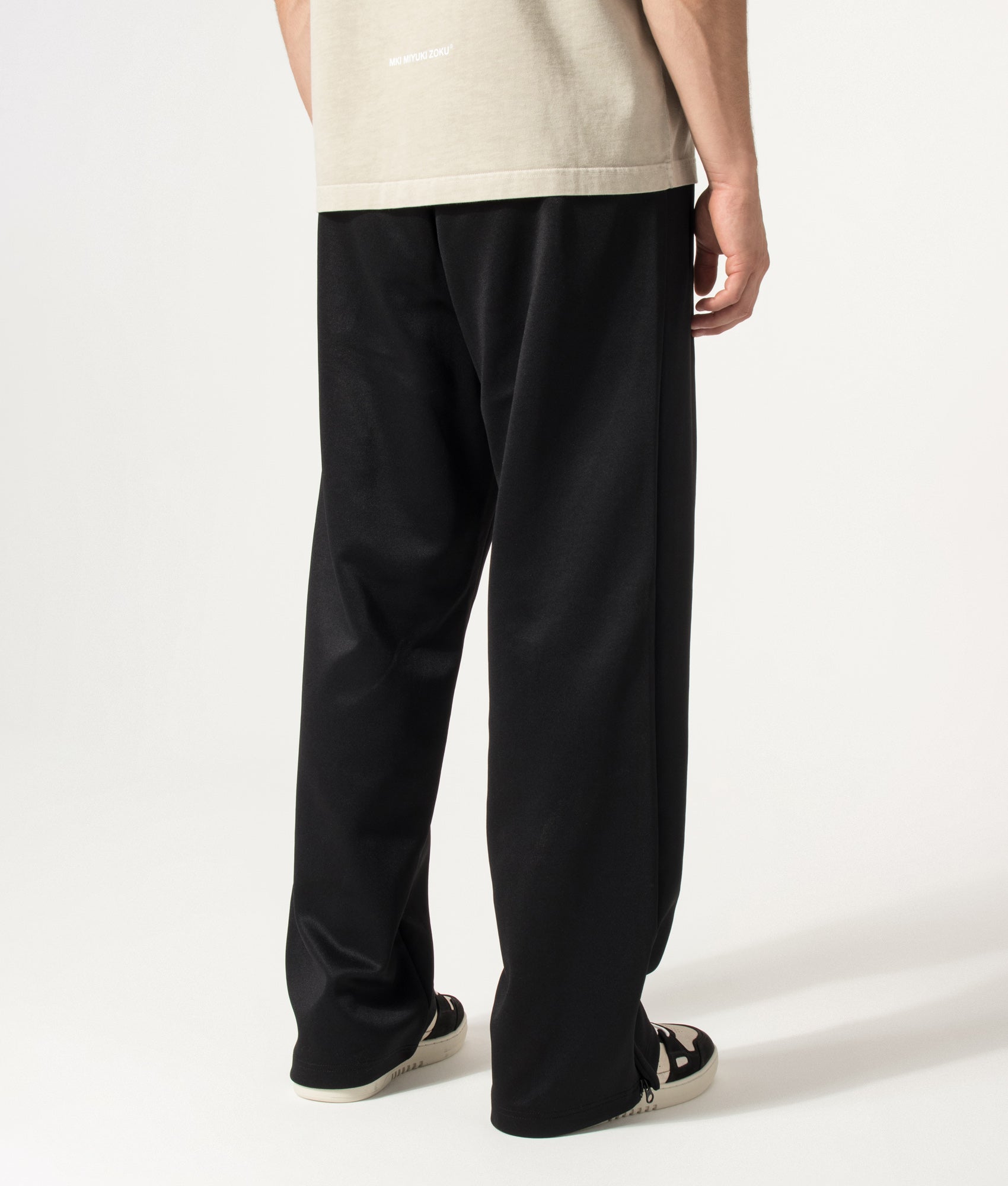 Carhartt WIP Loose Fit Bolon Sweat Pant in Black at EQVVS Menswear. Angled model back shot.