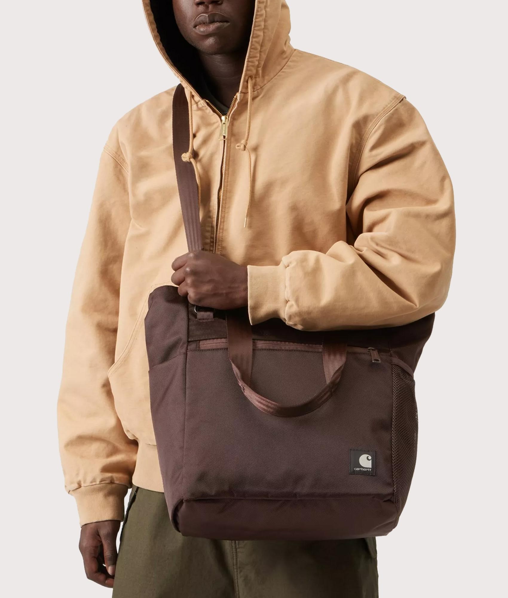 Carhartt WIP Richmond Tote Bag in Palisander at EQVVS Menswear. Model shot.