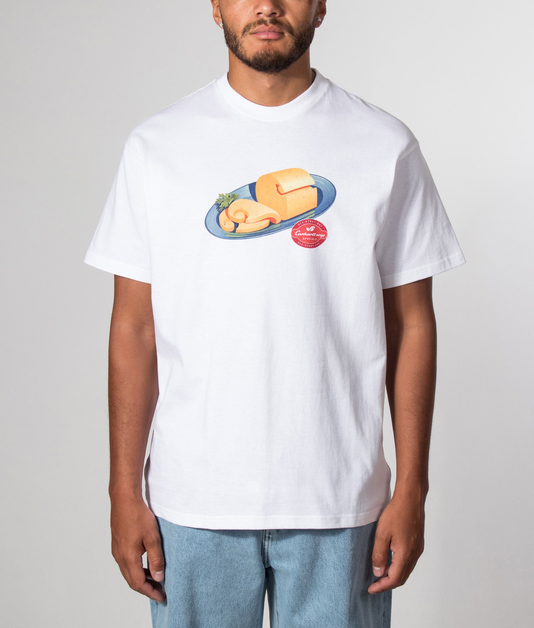 Carhartt WIP Loose Fit Fromage T-Shirt in White at EQVVS Menswear. Model front shot.