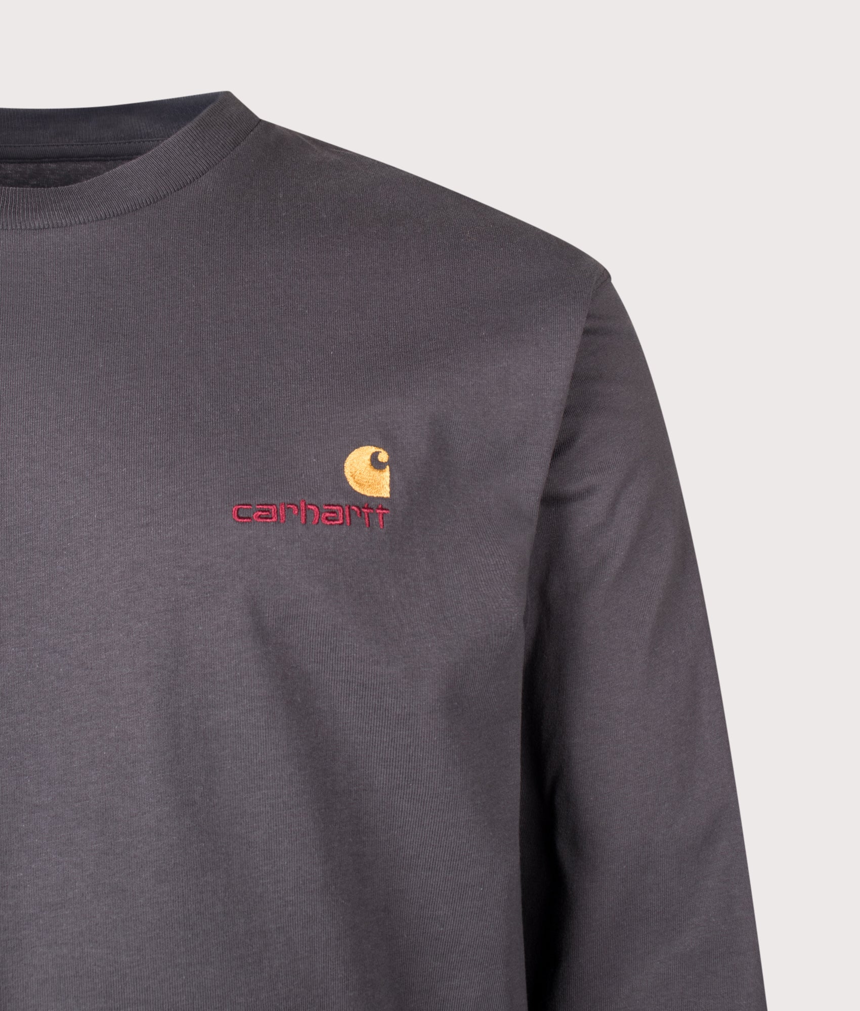 Carhartt WIP Loose Fit American Script Long Sleeve T-Shirt in Graphite at EQVVS Menswear. Detail shot.