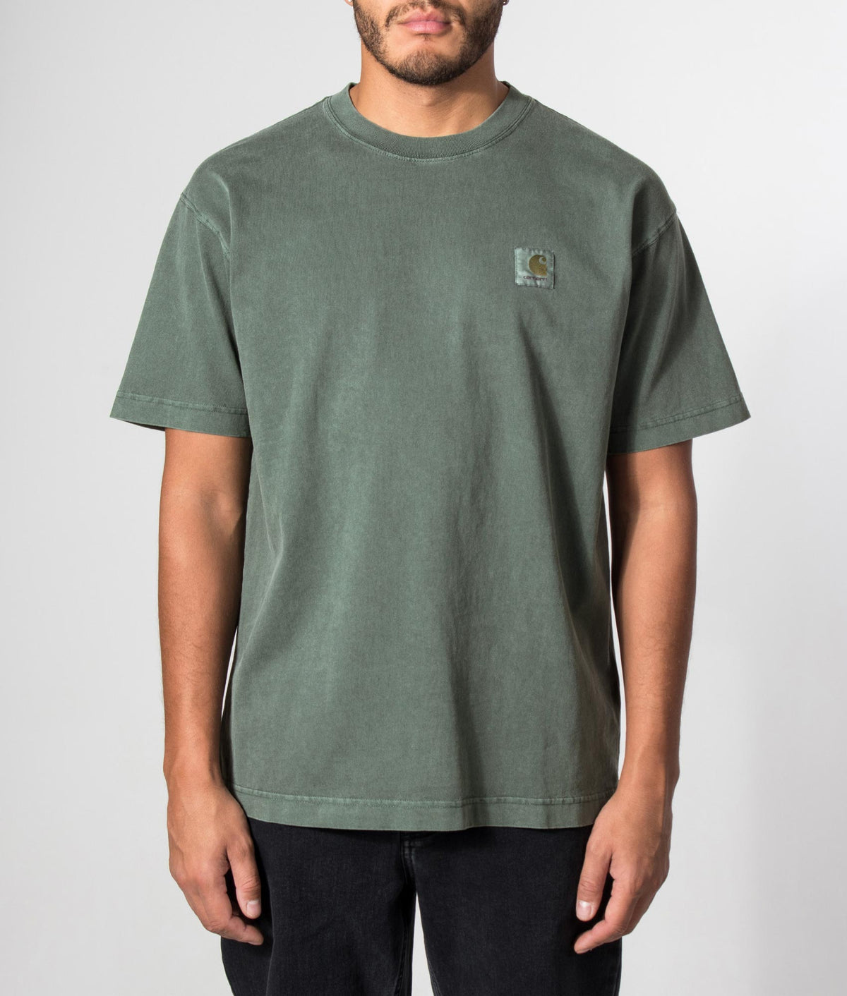 Carhartt WIP Loose Fit Vista T-Shirt in Dark Scarab at EQVVS Menswear. Model front shot.