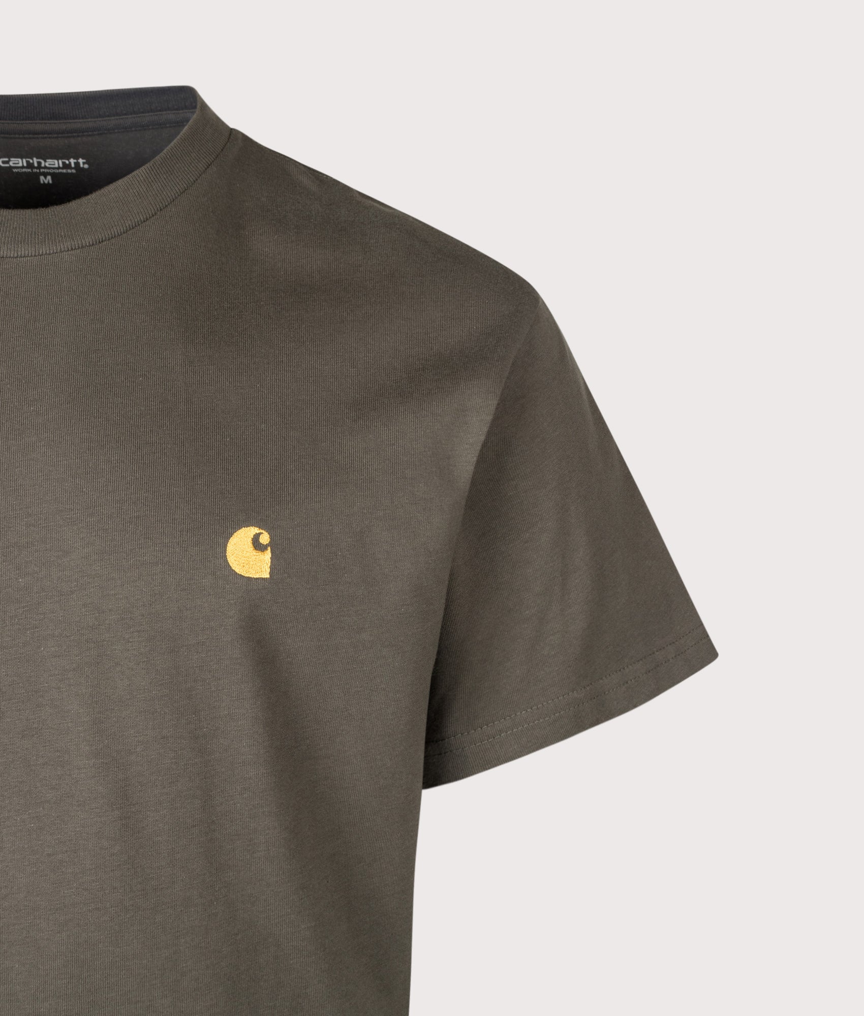 Carhartt WIP Loose Fit Chase T-Shirt in Shungite/Gold at EQVVS Menswear. Detail shot.