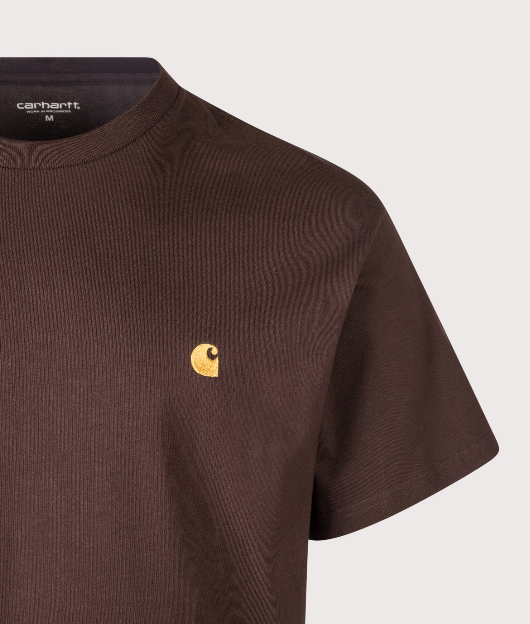 Carhartt WIP Loose Fit Chase T-Shirt in Palisander and Gold at EQVVS Menswear. Detail shot.
