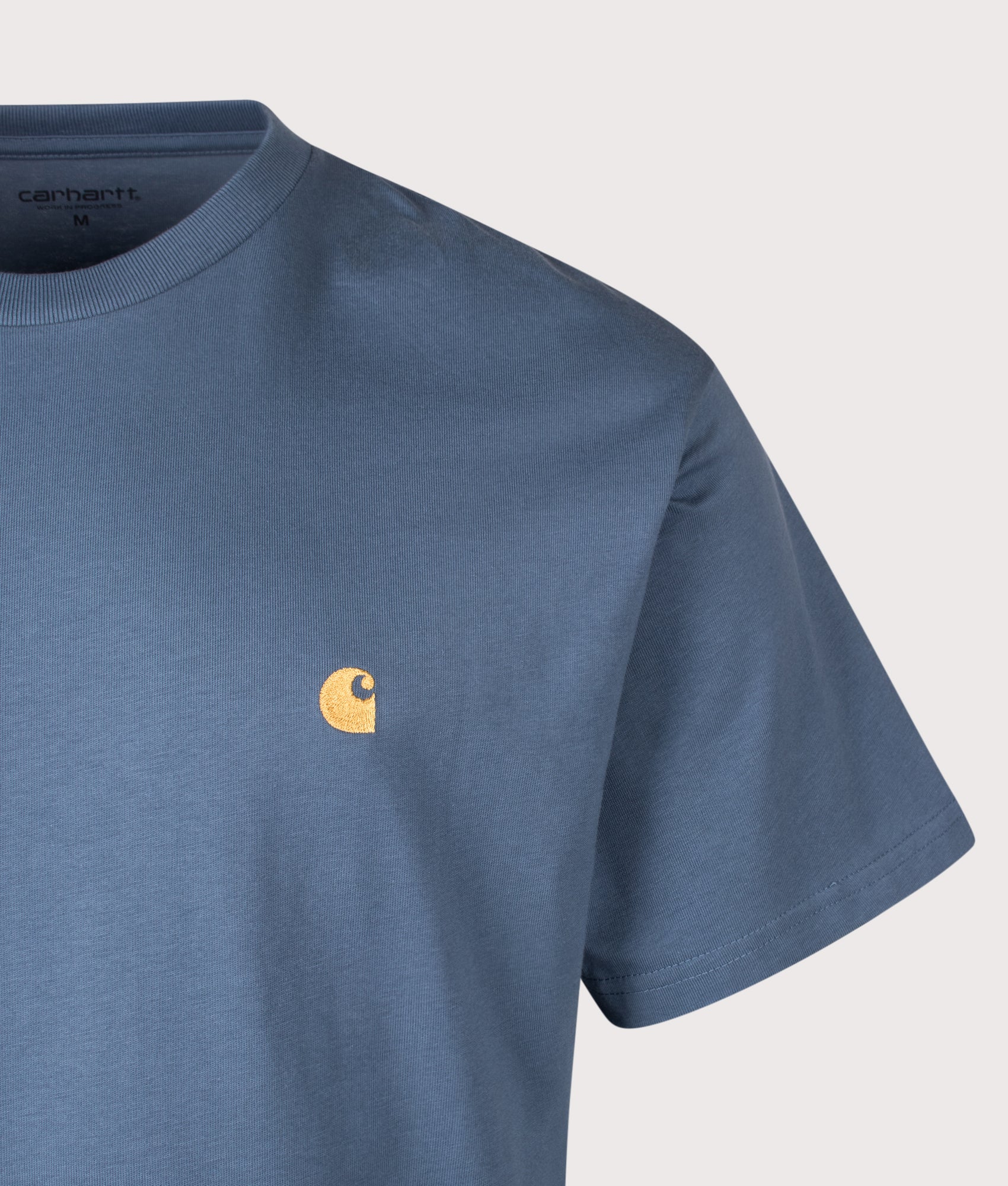 Carhartt WIP Loose Fit Chase T-Shirt in Icesheet and Gold at EQVVS Menswear. Detail shot.