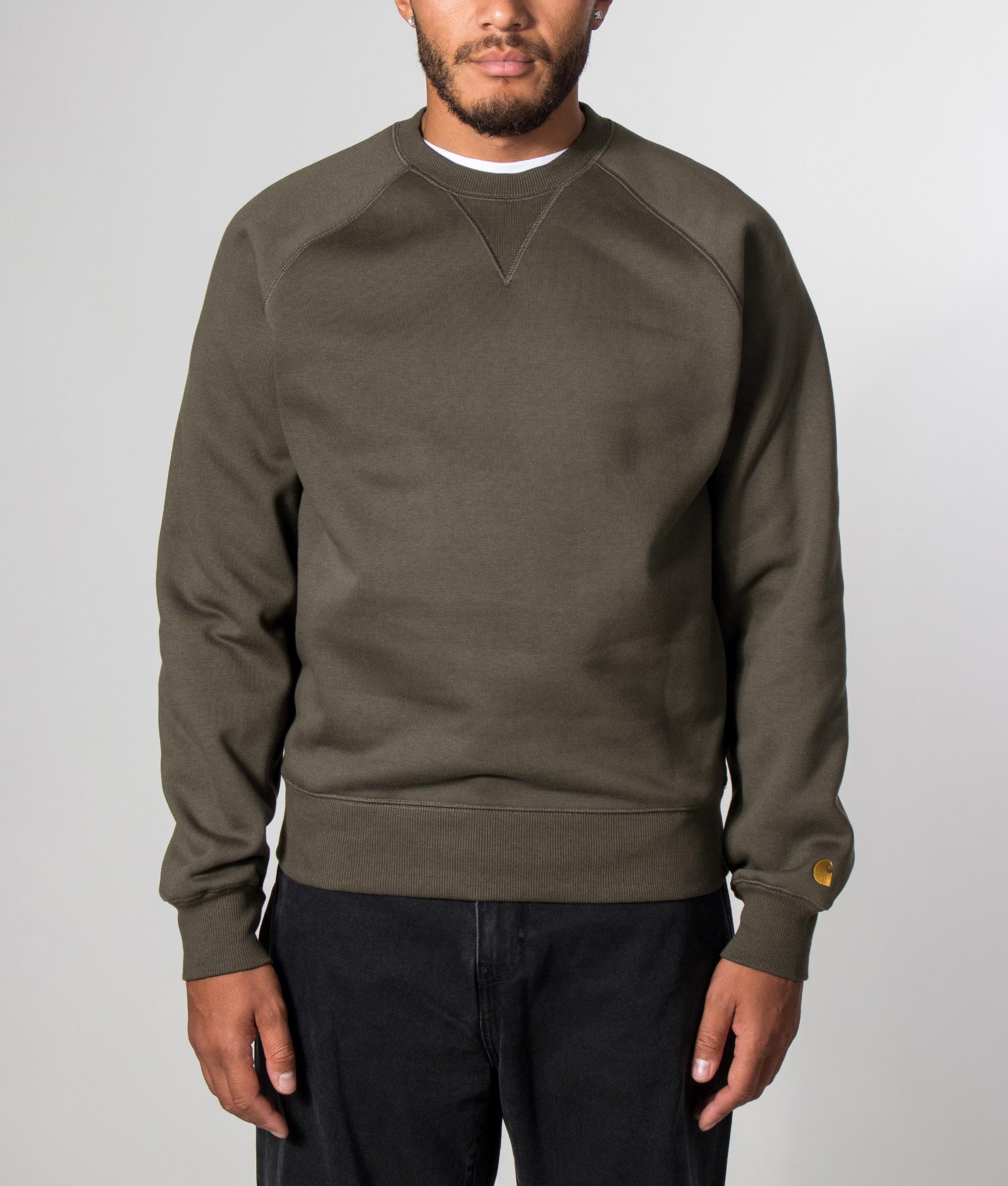Carhartt WIP Regular Fit Chase Sweatshirt in Shungite and Gold at EQVVS Menswear. Model front shot.