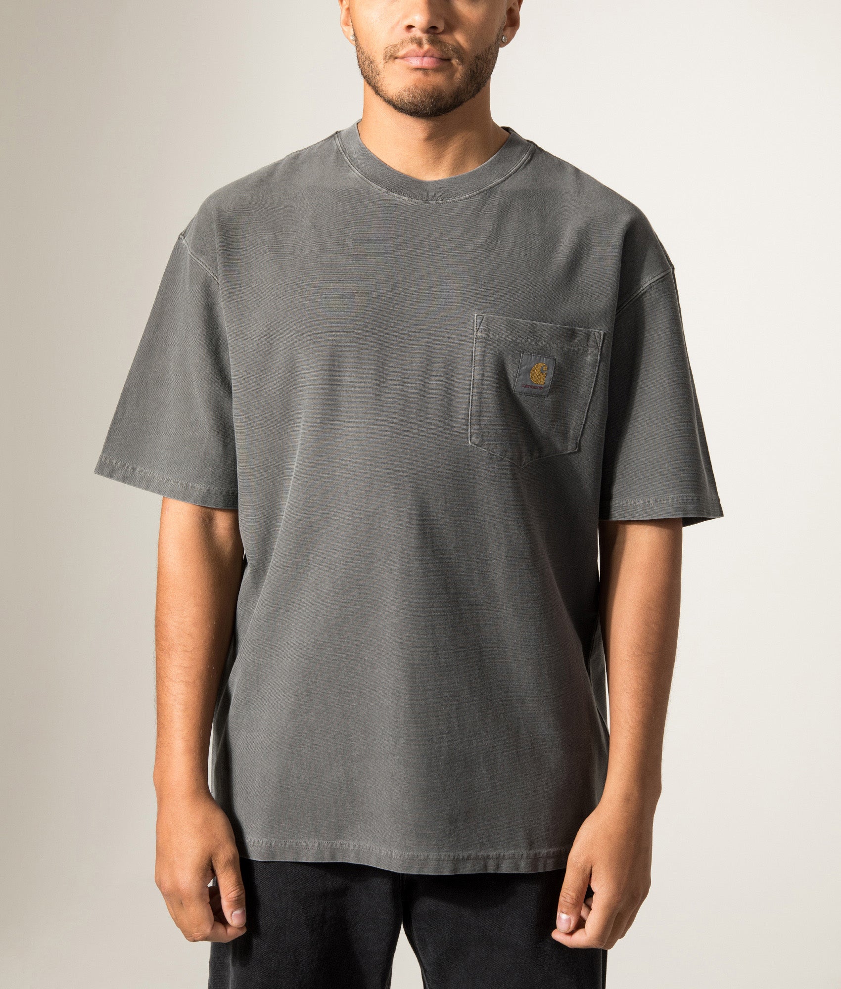 Carhartt WIP Oversized Fit Pocket T-Shirt in Black at EQVVS Menswear. Model front shot.
