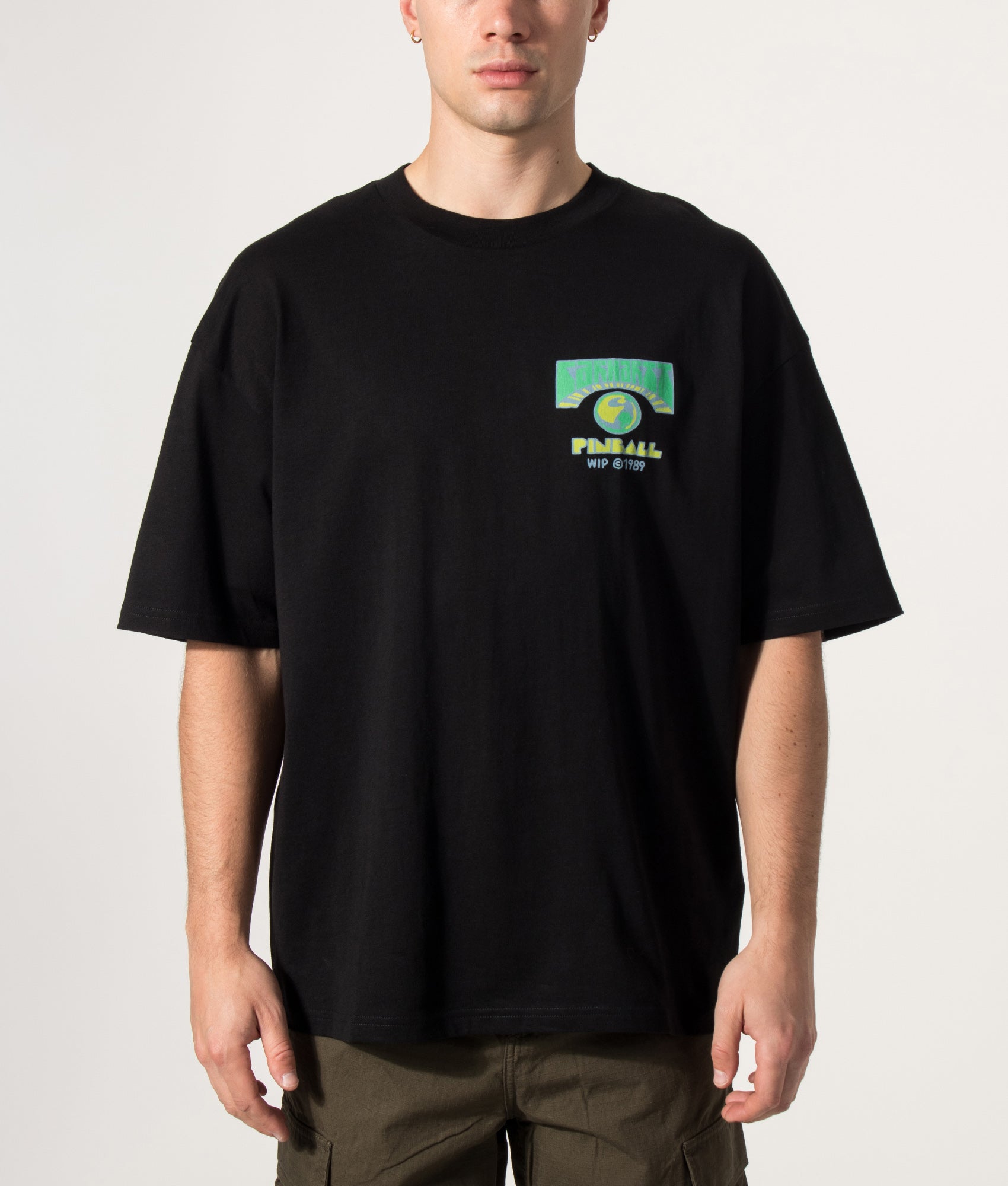 Carhartt WIP Oversized Fit Pinball T-Shirt in Black at EQVVS Menswear. Model front shot.