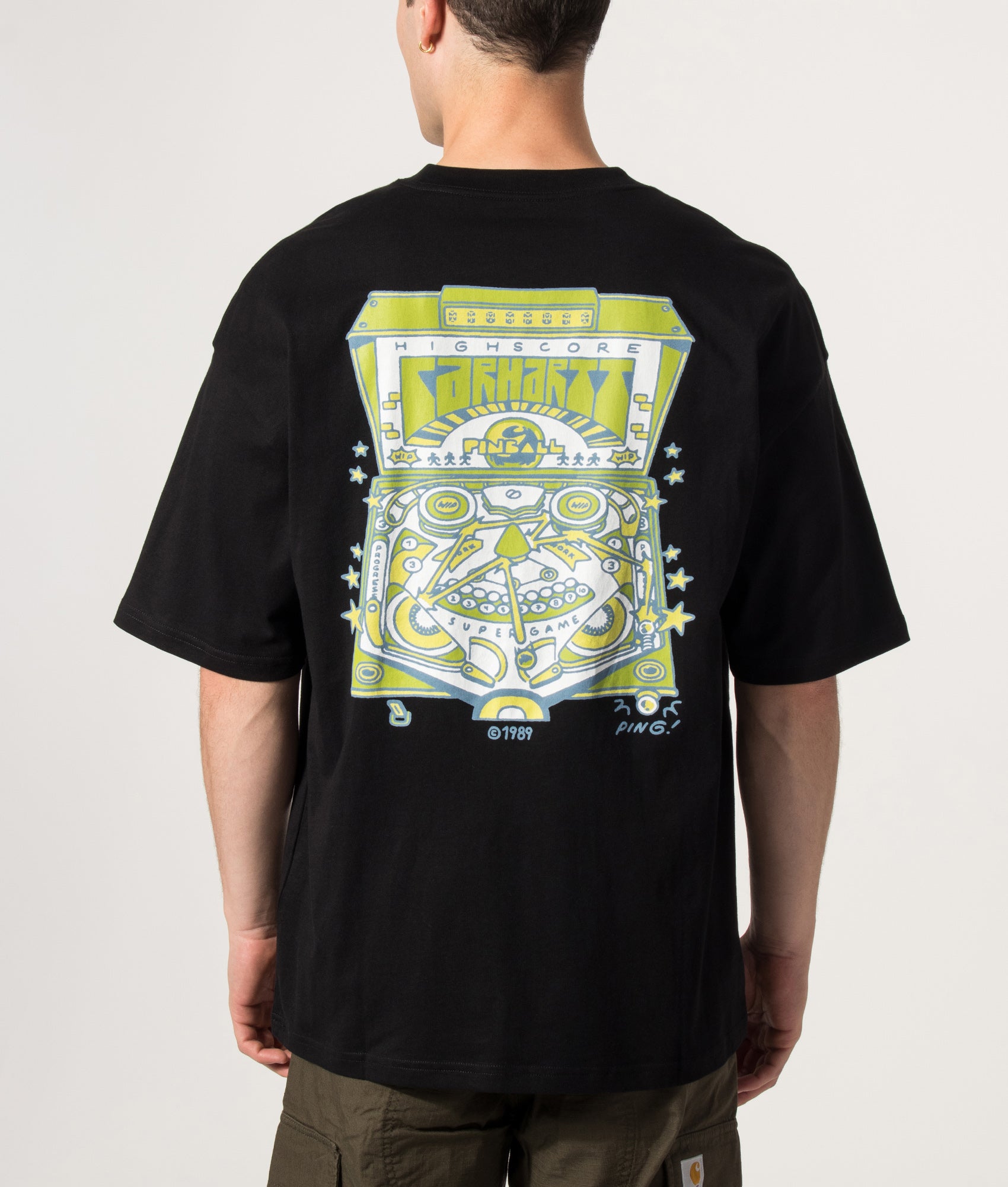 Carhartt WIP Oversized Fit Pinball T-Shirt in Black at EQVVS Menswear. Model back shot.