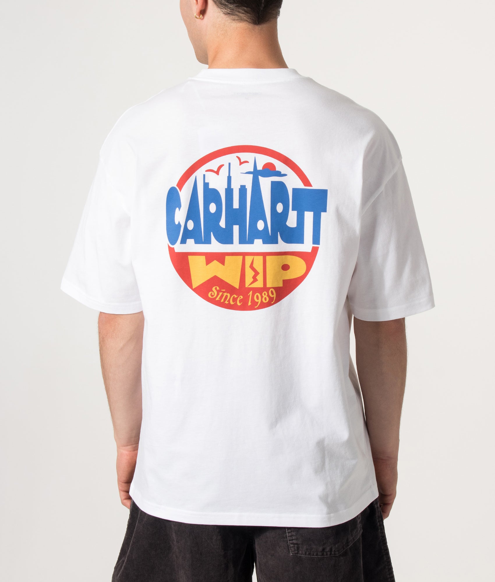 Carhartt WIP Oversized Fit Luggage Label T-Shirt in White at EQVVS Menswear. Model back shot.