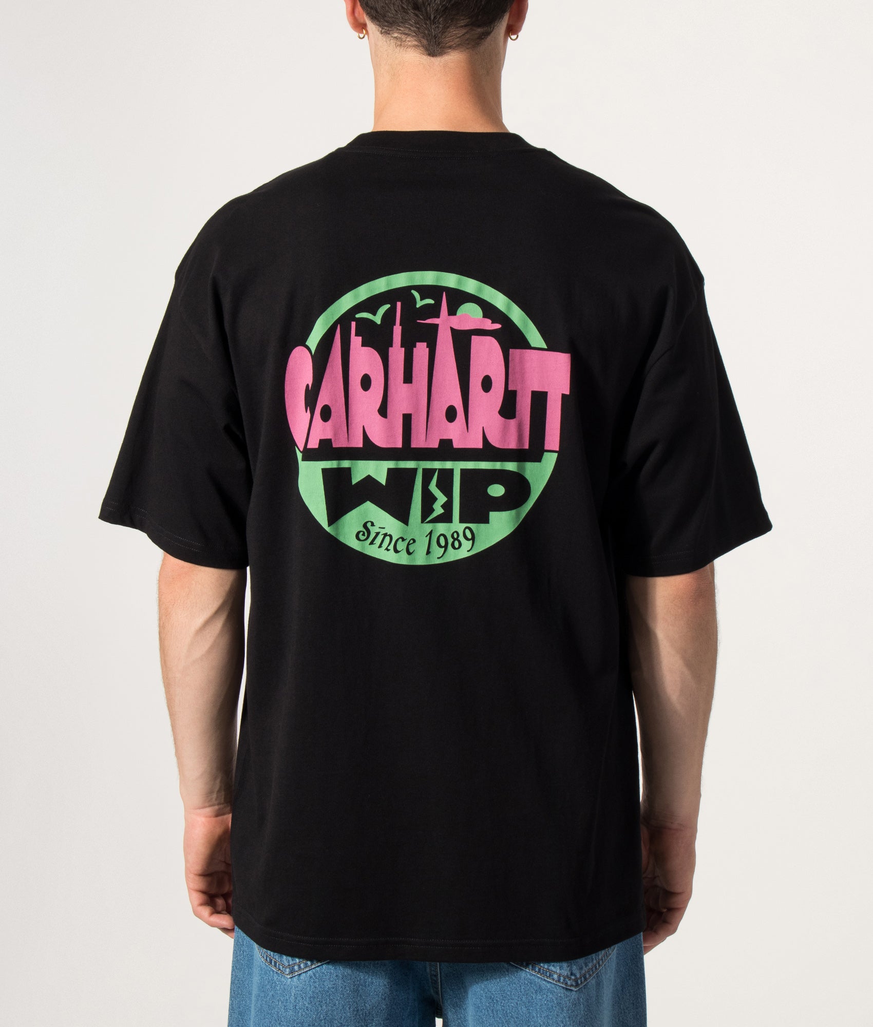 Carhartt WIP Oversized Fit Luggage Label T-Shirt in Black at EQVVS Menswear. Model back shot.