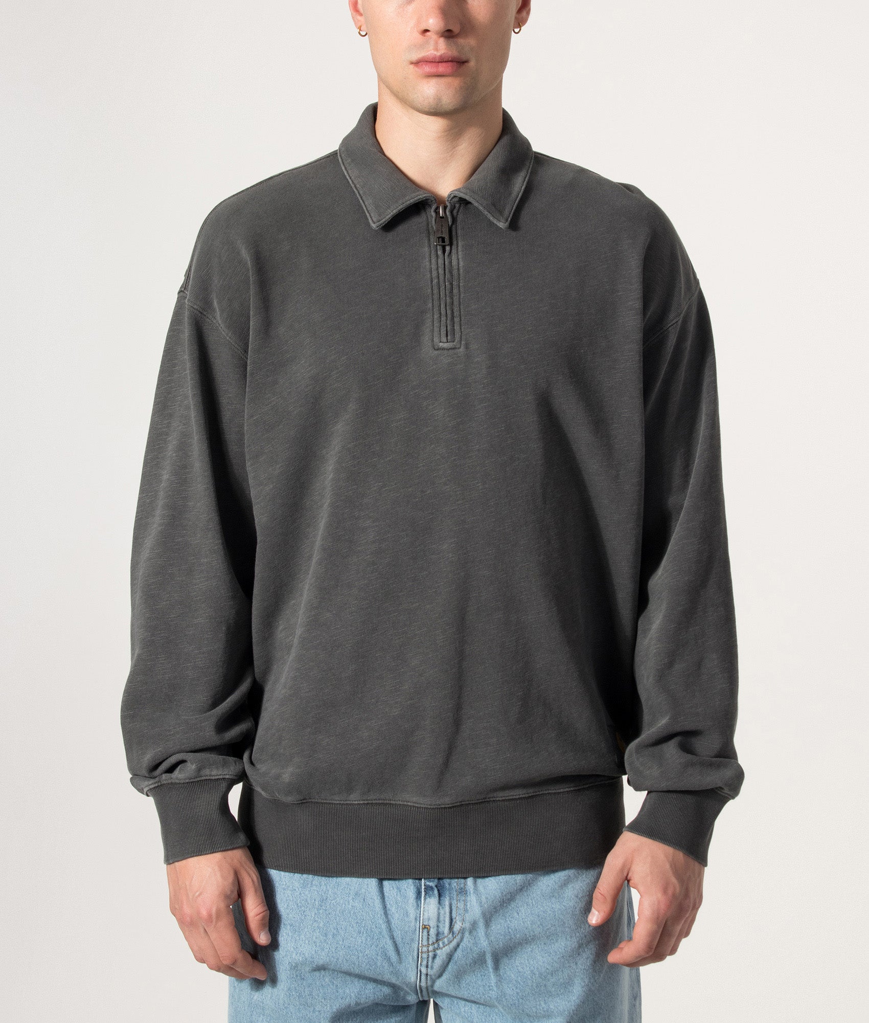 Carhartt WIP Balloon Fit Harper Quarter Zip Sweatshirt in Garment Dyed Black at EQVVS Menswear. Model front shot.