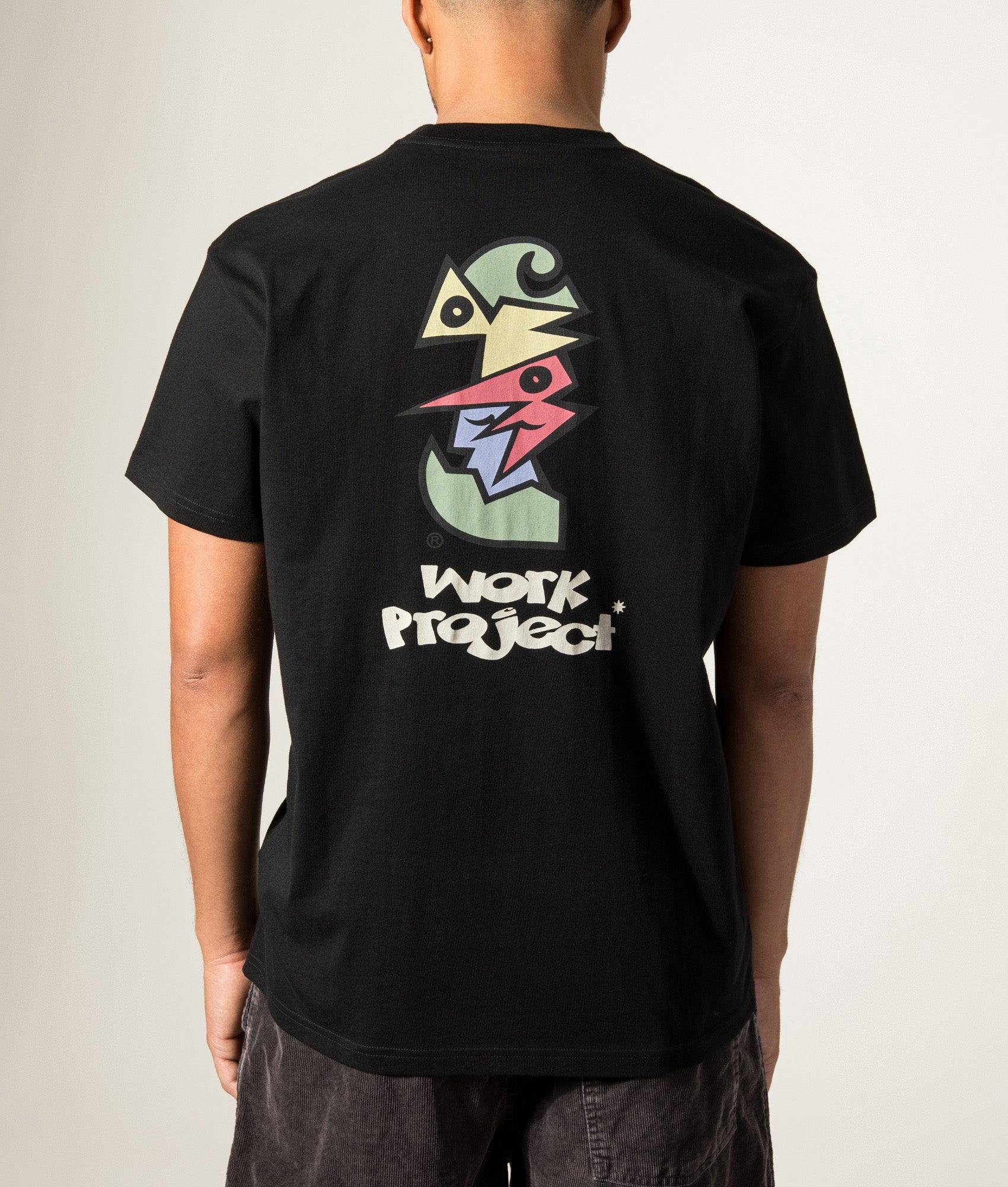 Carhartt WIP Loose Fit Cubist T-Shirt in Black at EQVVS Menswear. Model back shot.