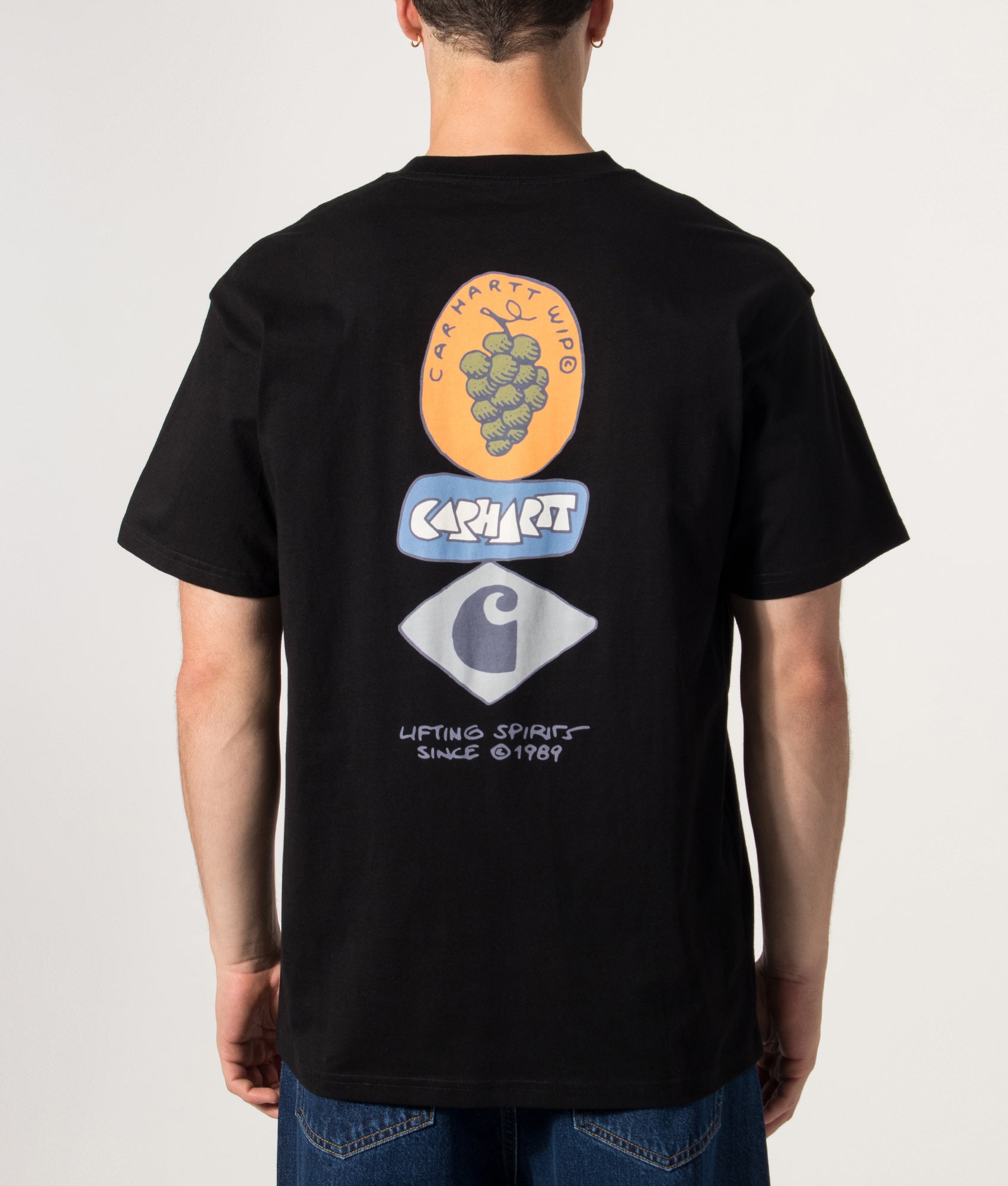 Carhartt WIP Loose Fit Stacked Grapes T-Shirt in Black at EQVVS Menswear. Model back shot.