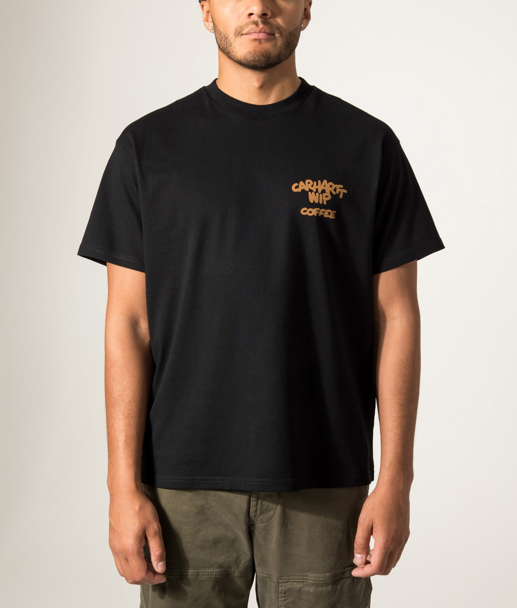 Carhartt WIP Loose Fit Coffee Break T-Shirt in Black at EQVVS Menswear. Model front shot.