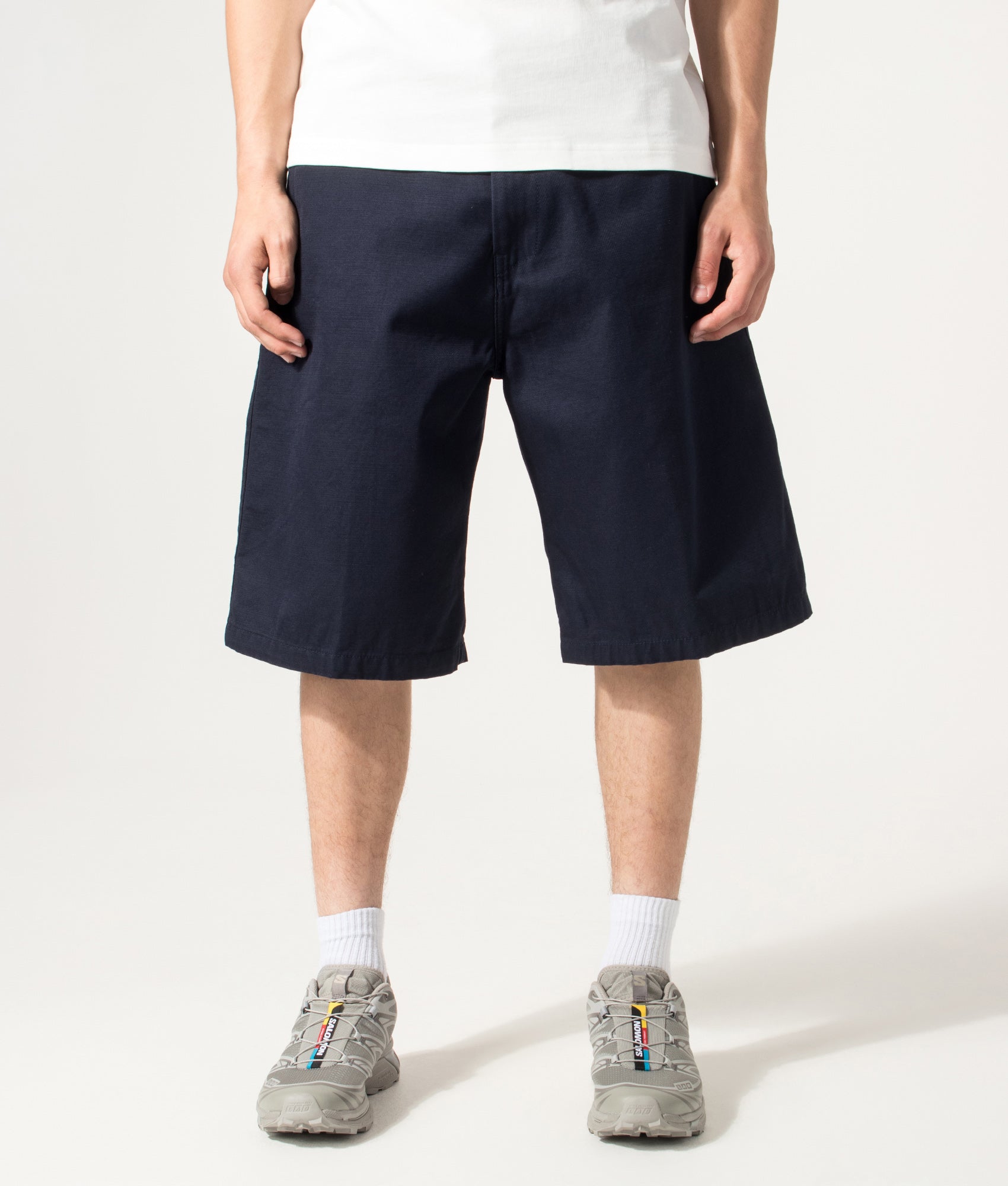 Carhartt WIP Loose Fit Brader Shorts in  Dark Navy at EQVVS Menswear. Model front shot.