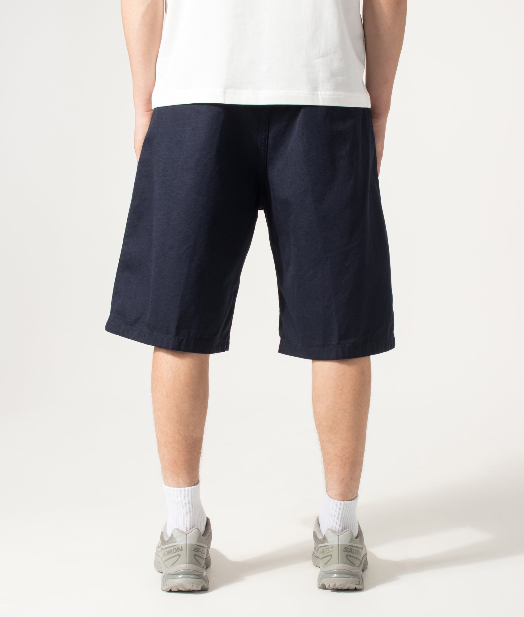 Carhartt WIP Loose Fit Brader Shorts in  Dark Navy at EQVVS Menswear. Model back shot.