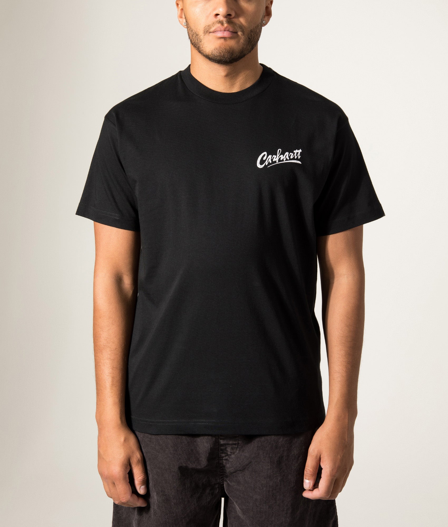 Carhartt WIP Loose Fit Pup T-Shirt in Black at EQVVS Menswear. Model front shot.