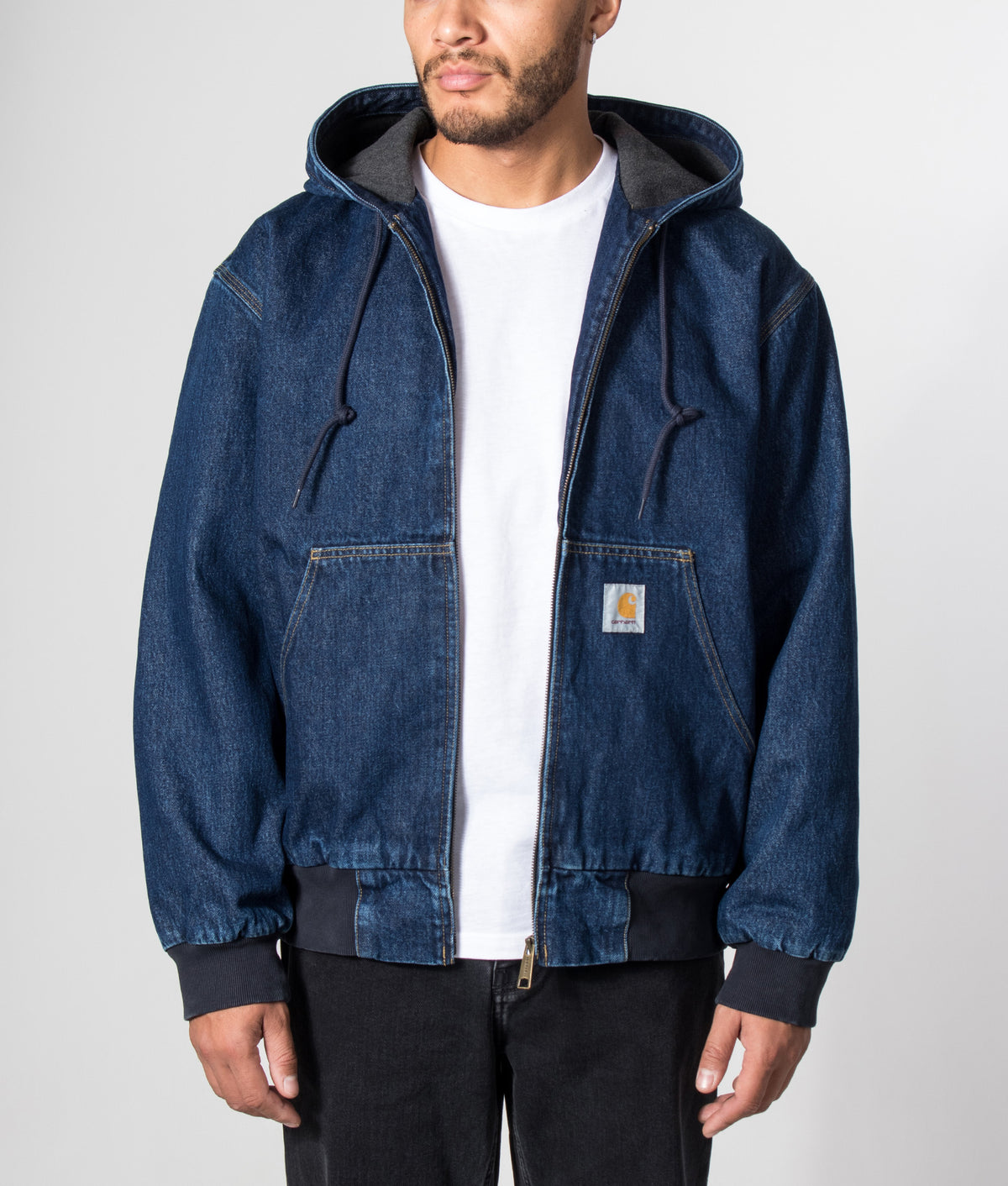 Carhartt WIP Loose Fit OG Active Jacket in Blue Stone Washed at EQVVS Menswear. Model front shot.