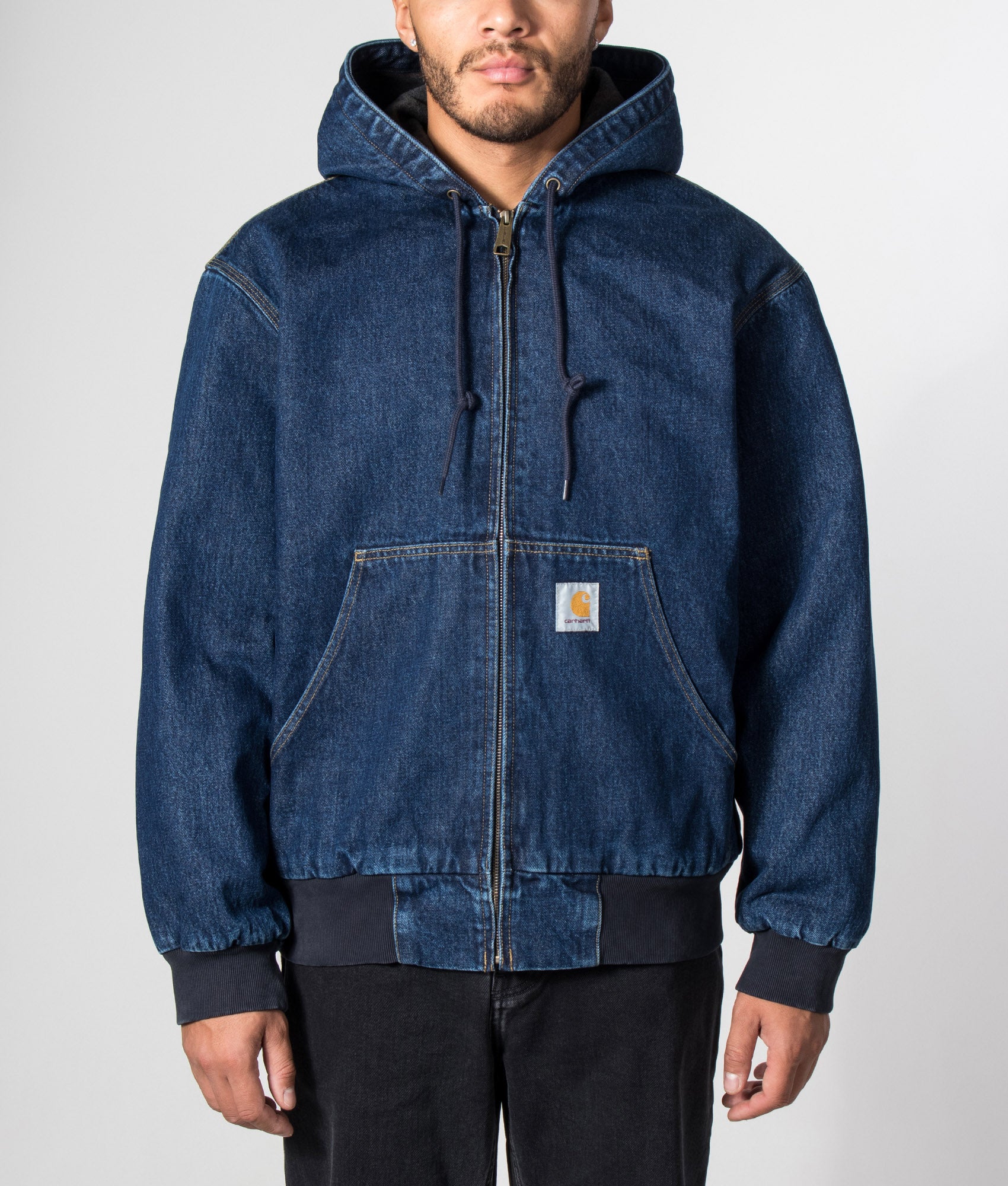 Carhartt WIP Loose Fit OG Active Jacket in Blue Stone Washed at EQVVS Menswear. Model front shot.