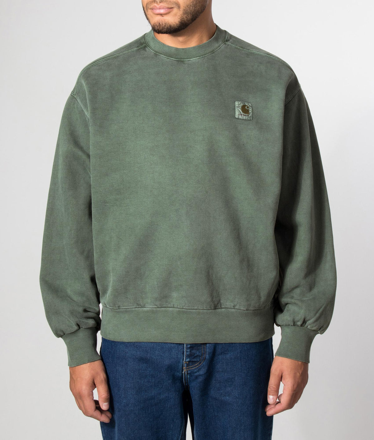Carhartt WIP Balloon Fit Vista Sweatshirt in Dark Scarab at EQVVS Menswear. Model front shot. 