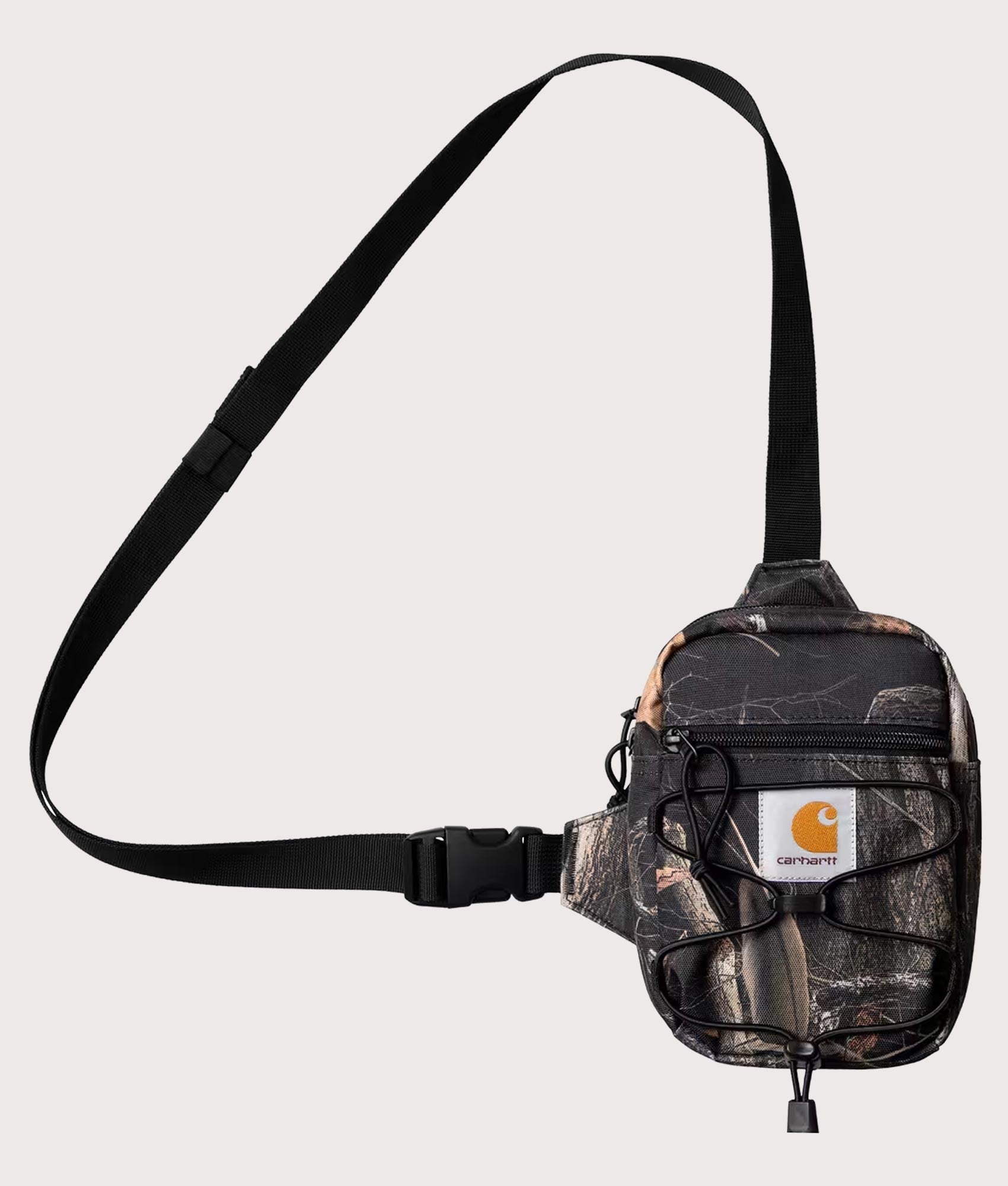 Carhartt WIP Kickflip Shoulder Bag in Camo Feather Tree and Black at EQVVS Menswear. Front shot.