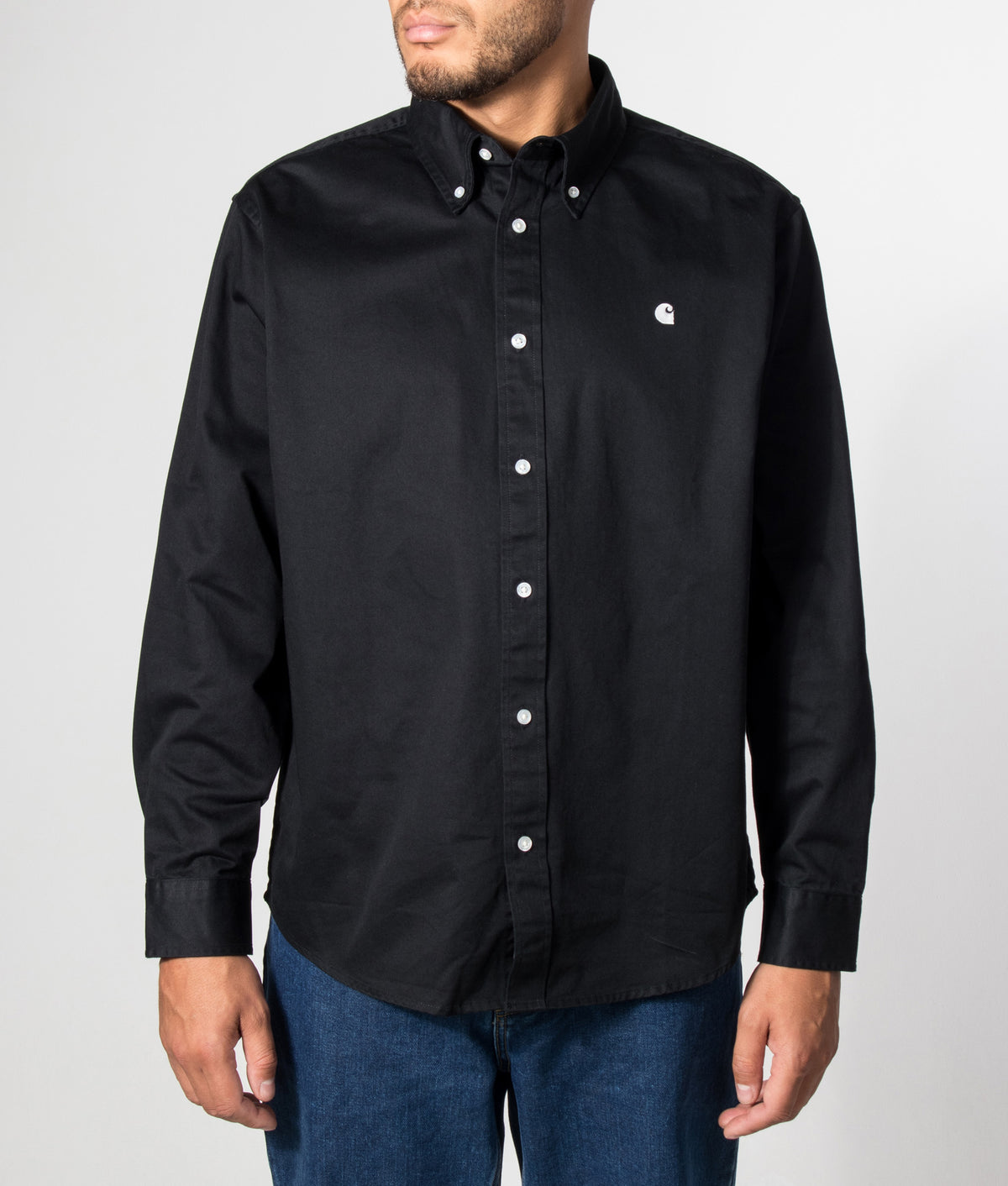 Carhartt WIP Loose Fit OG Madison Shirt in Black at EQVVS Menswear. Model front shot.