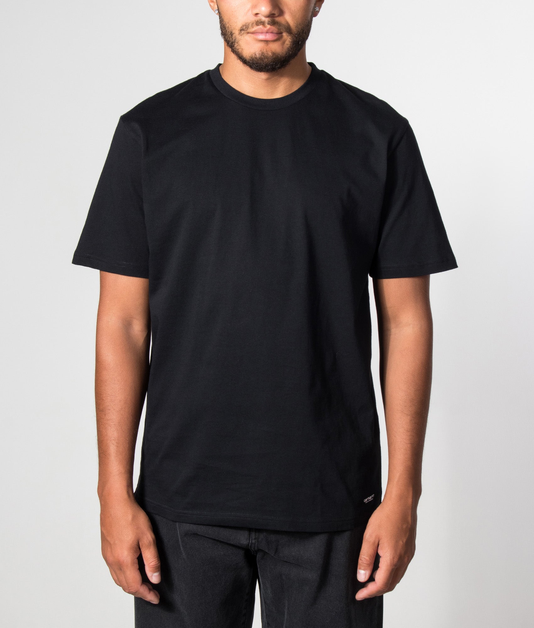 Carhartt WIP 2 Pack Standard Crew Neck T-Shirt in Black at EQVVS Menswear. Model front shot.
