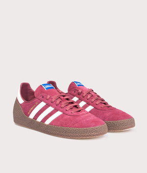 Adidas Montreal 76 Trainers in Noble Maroon/Off White/Gum at EQVVS Menswear. Angled front shot. 