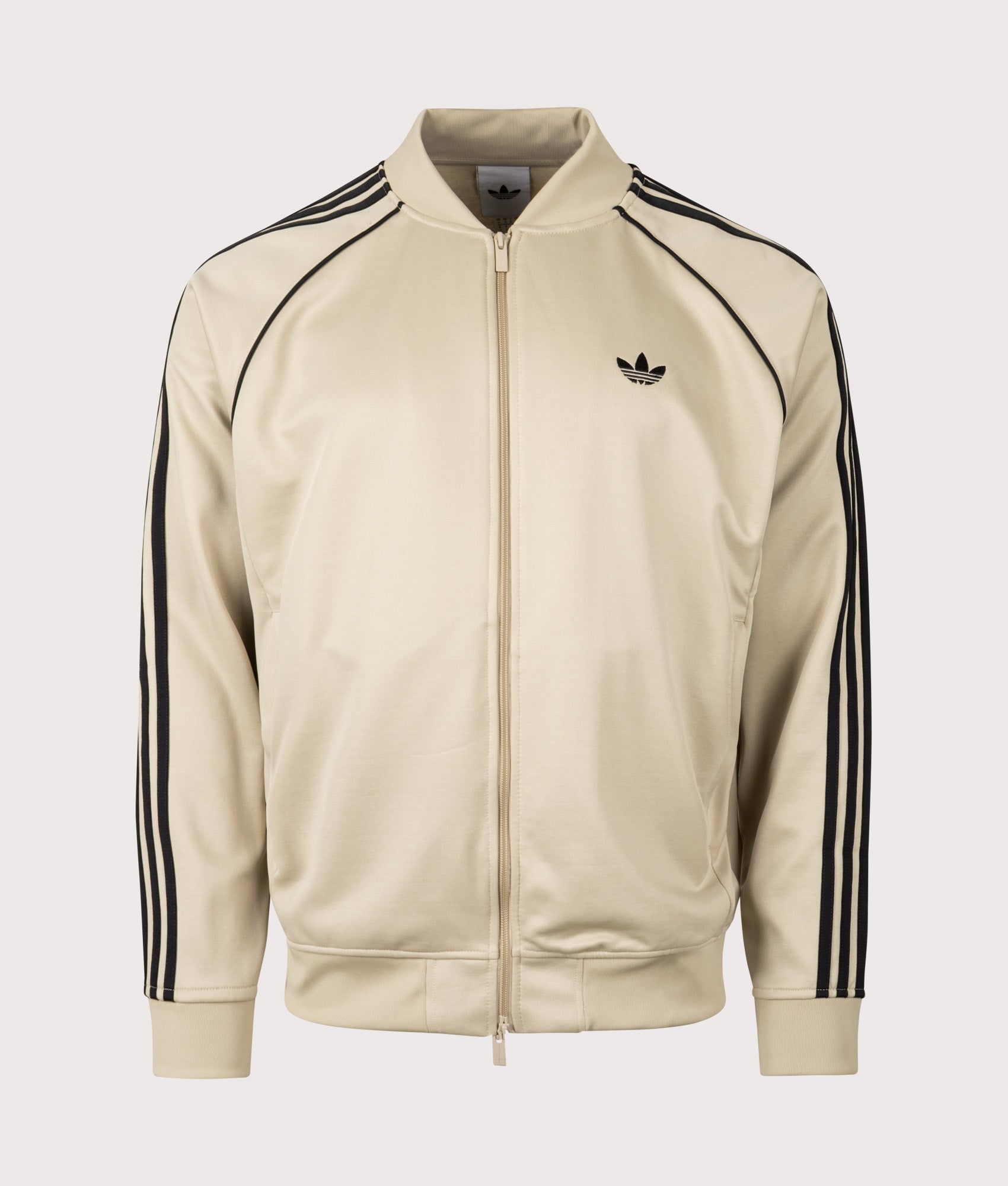 adidas Originals SST Track Top in Stone Khaki and Black at EQVVS Menswear. Front shot.
