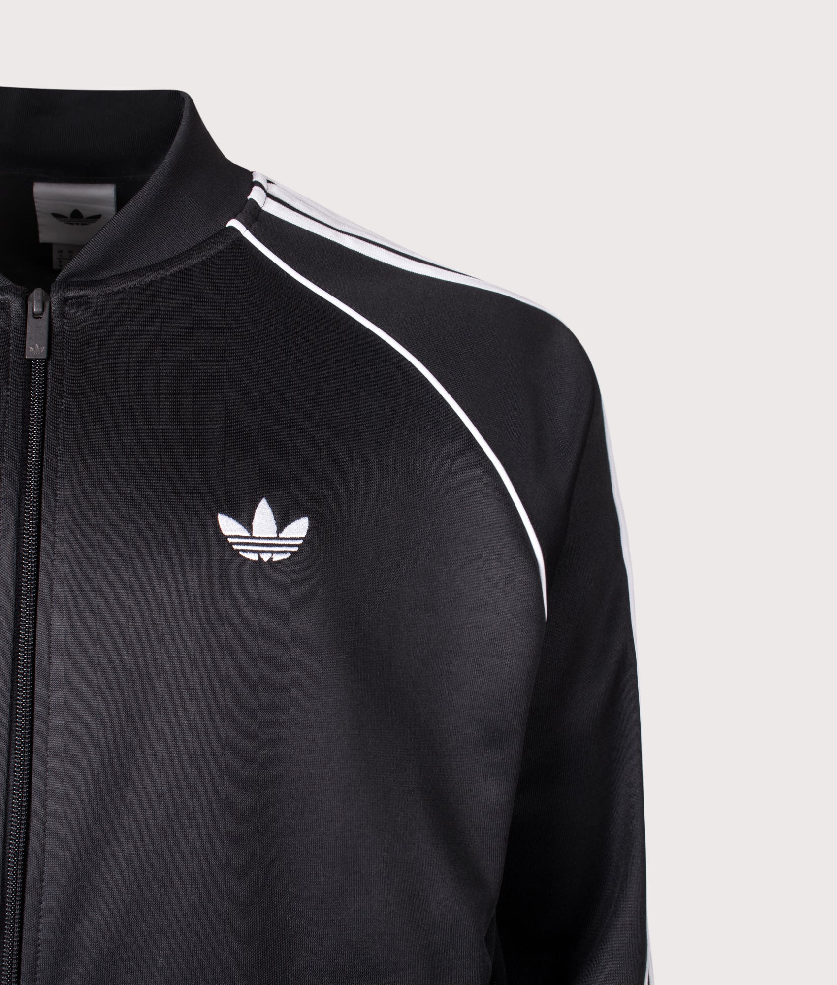 adidas Originals SST Track Top in Black and White at EQVVS Menswear. Angled front shot. Detail shot.