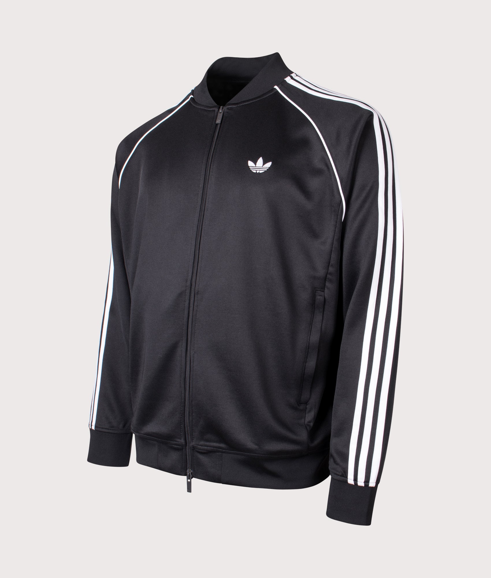 adidas Originals SST Track Top in Black and White at EQVVS Menswear. Angled front shot.