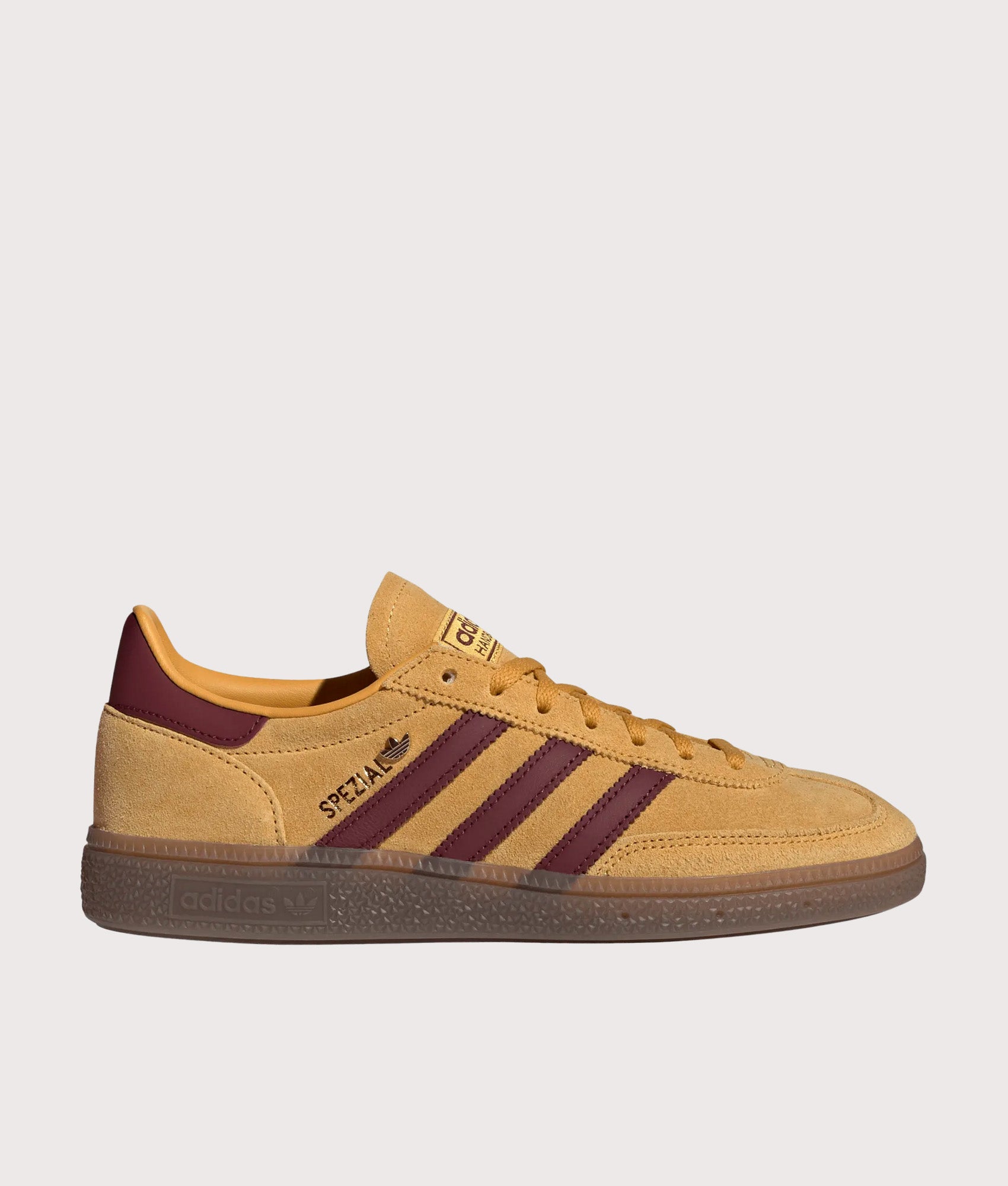 adidas Originals Handball Spezial Trainers in Preloved Yellow, Shadow Red and Gold Metallic at EQVVS Menswear. Side shot.