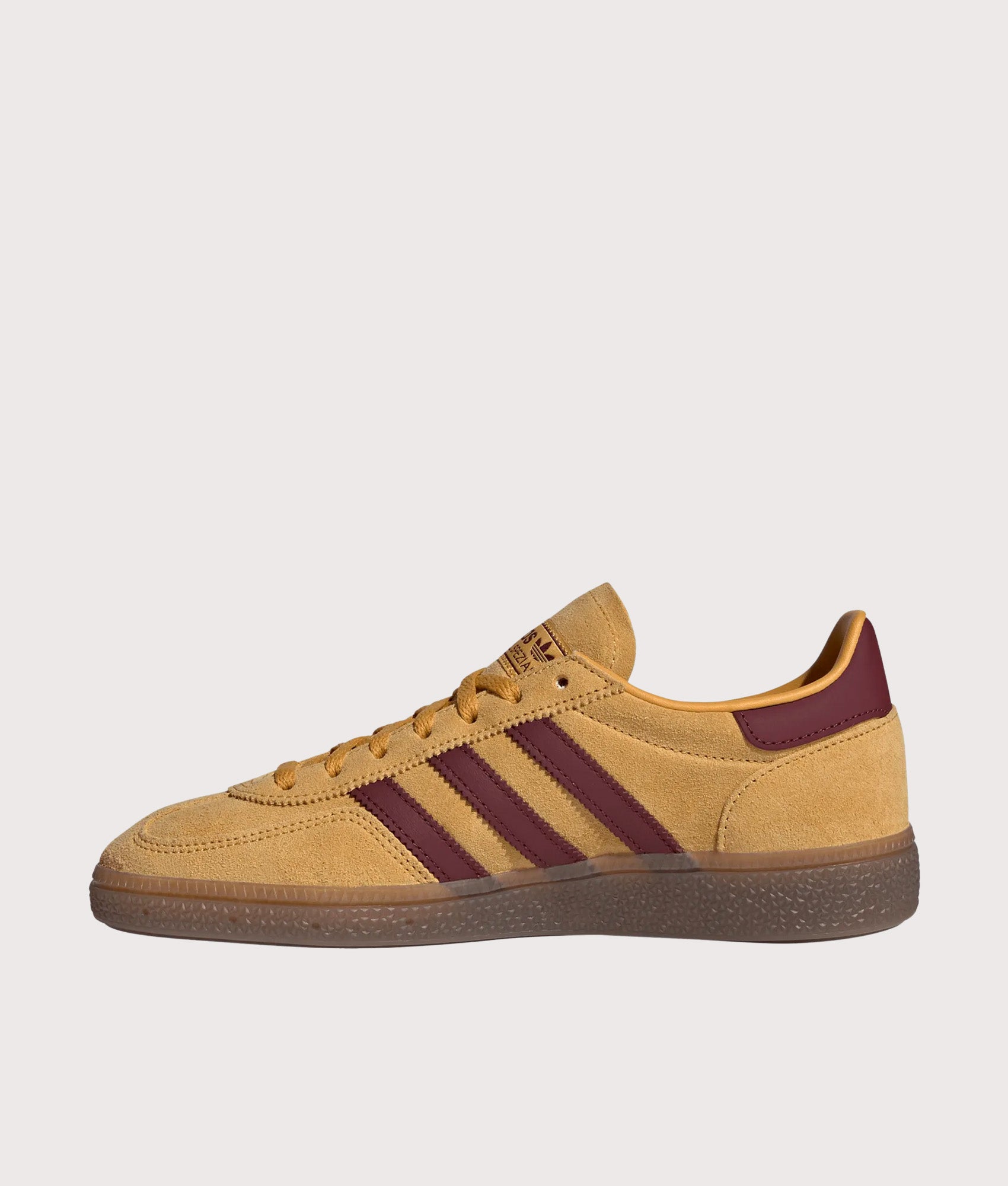 adidas Originals Handball Spezial Trainers in Preloved Yellow, Shadow Red and Gold Metallic at EQVVS Menswear. Side shot.