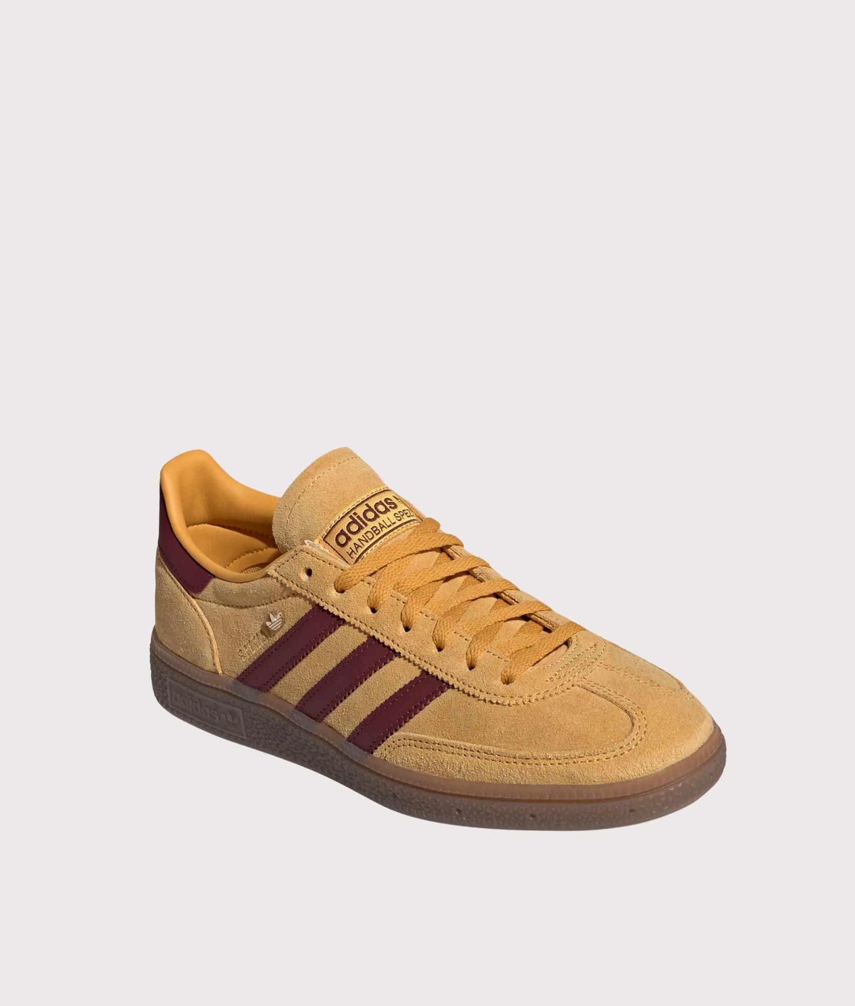 adidas Originals Handball Spezial Trainers in Preloved Yellow, Shadow Red and Gold Metallic at EQVVS Menswear. Angled front shot.