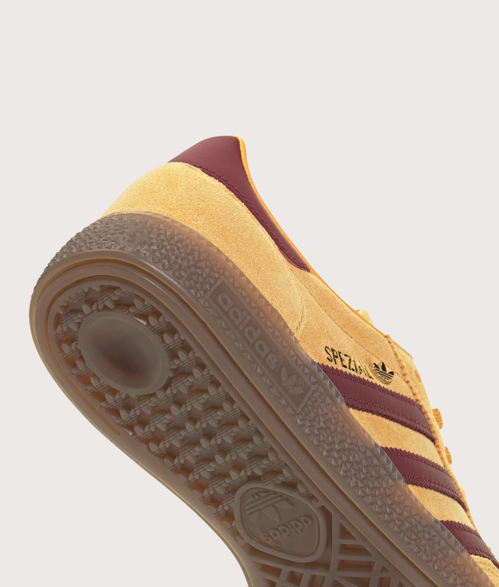 adidas Originals Handball Spezial Trainers in Preloved Yellow, Shadow Red and Gold Metallic at EQVVS Menswear. Tread detail shot.