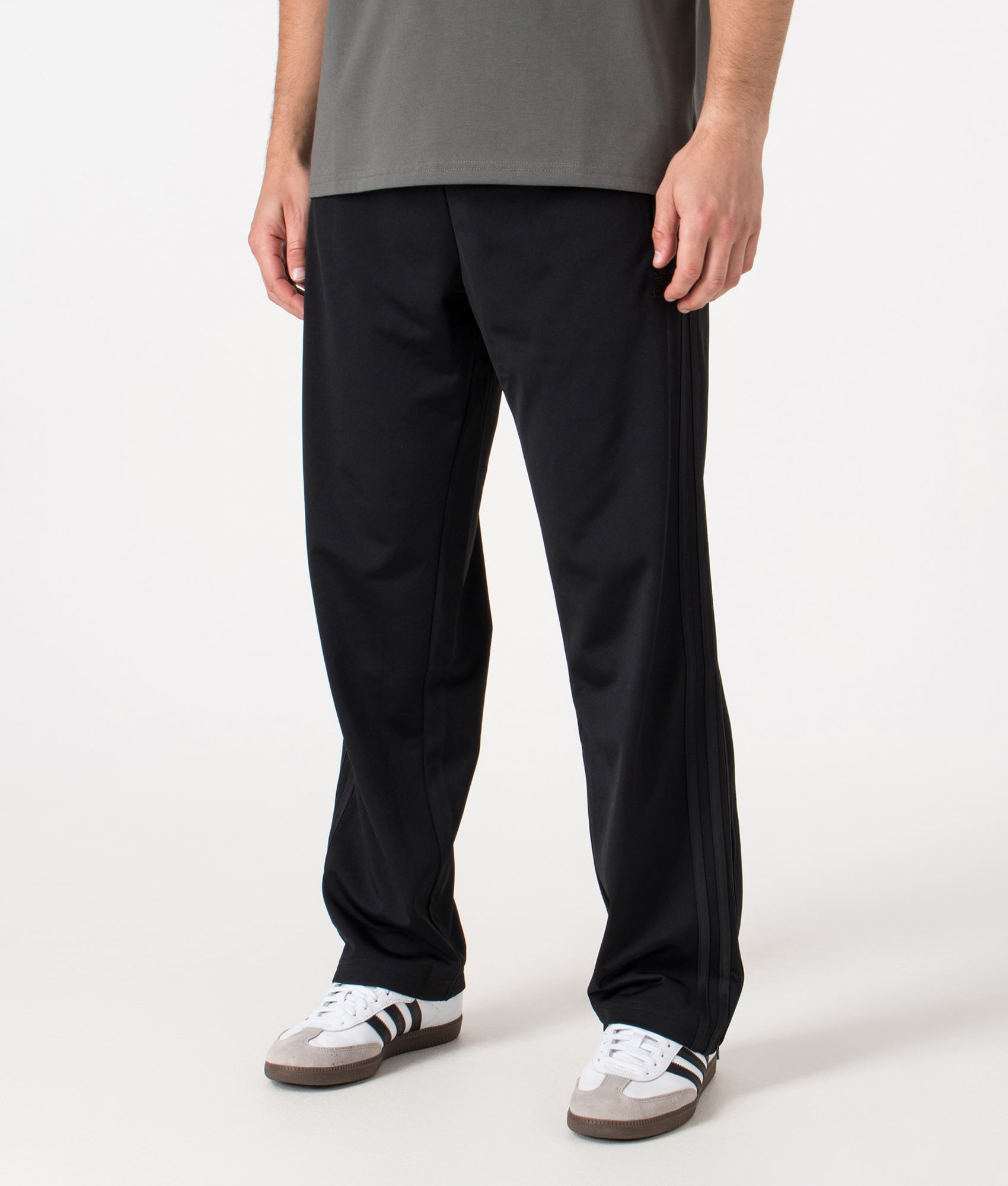 adidas Originals Fire Bird Track Pants at EQVVS Menswear. Angled front shot.
