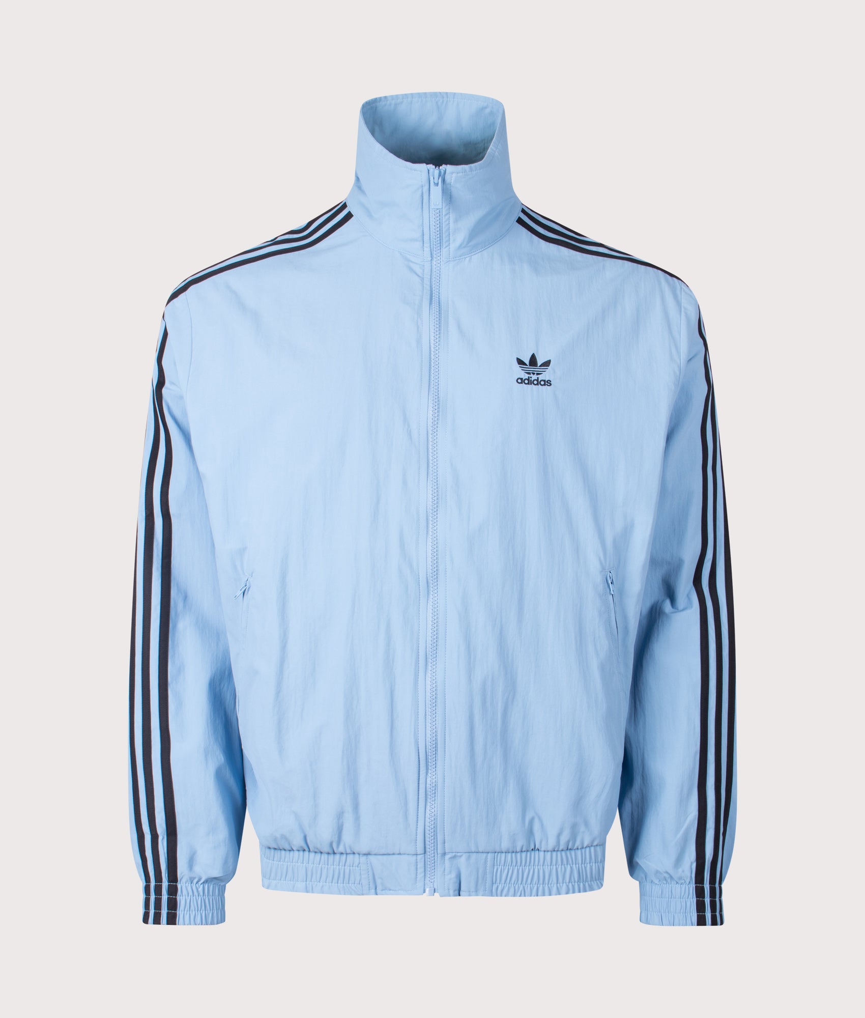 adidas Originals Firebird Track Top in Ash Blue/Black at EQVVS Menswear. Front shot.