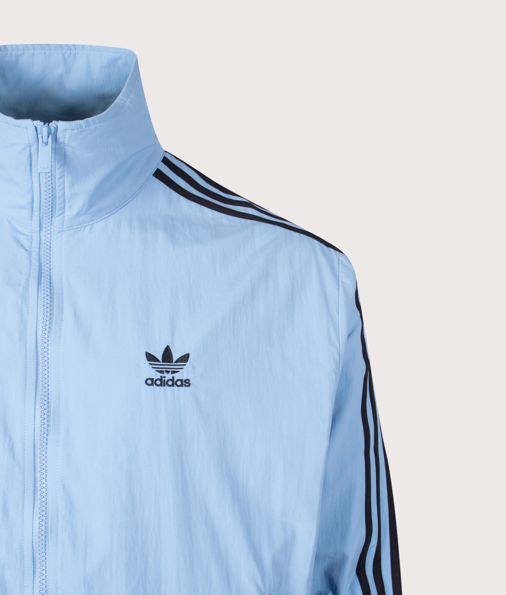 adidas Originals Firebird Track Top in Ash Blue/Black at EQVVS Menswear. Detail shot.