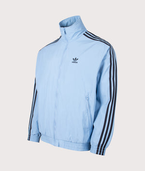 Firebird Track Top by adidas Originals in Ash Blue/Black. Shot by EQVVS. Front detail shot.