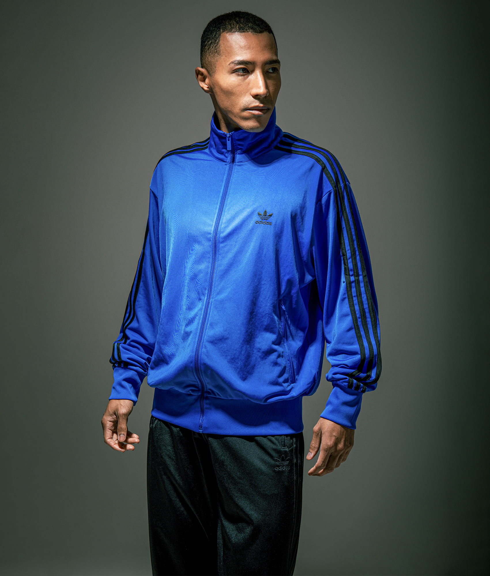 adidas Originals Firebird Track Top in Blue/Black at EQVVS Menswear. Campaign shot.