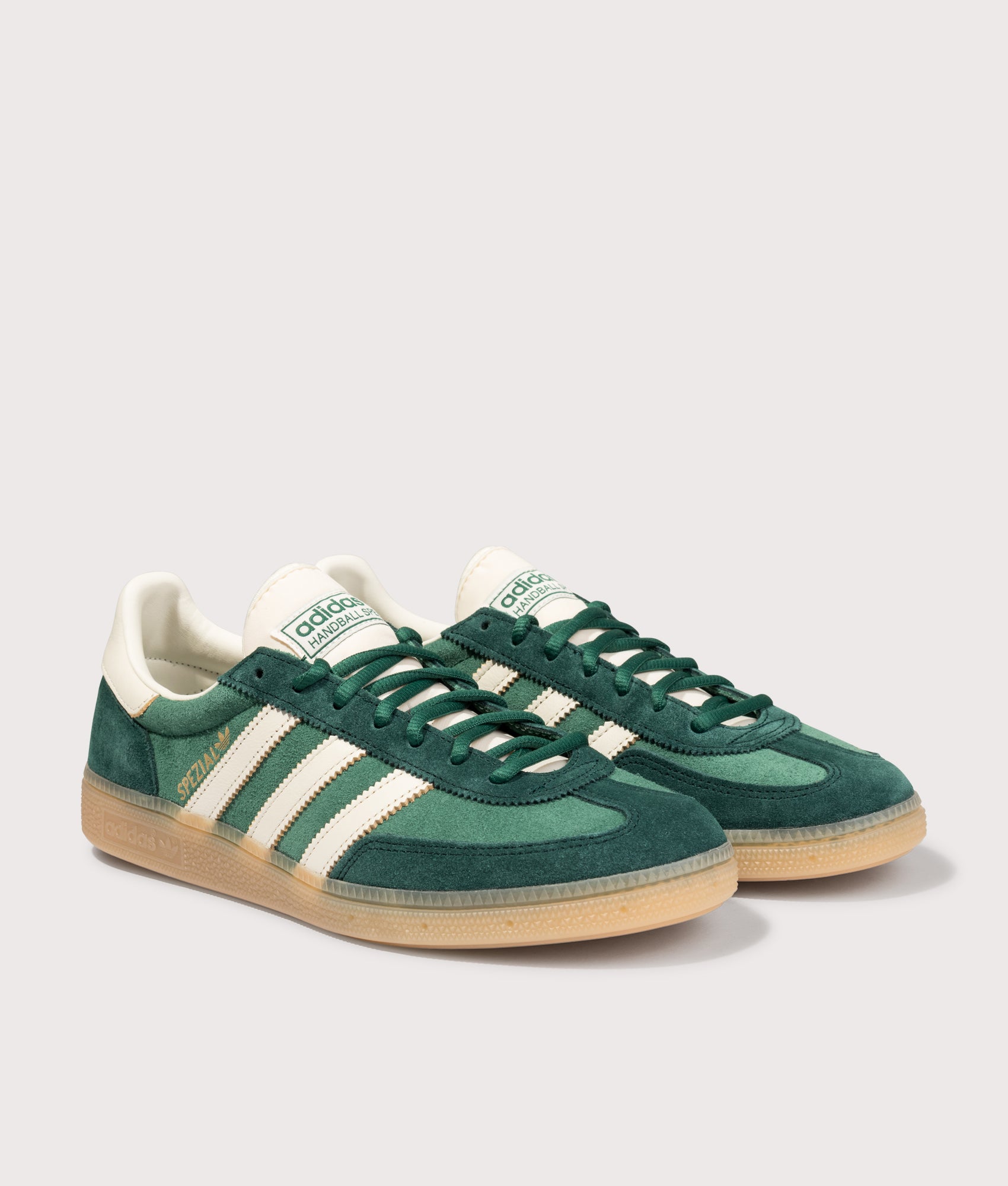 adidas Originals Handball Spezial Trainers in Collegiate Green/Off White/Aurora Ivy at EQVVS Menswear. Angled front shot.