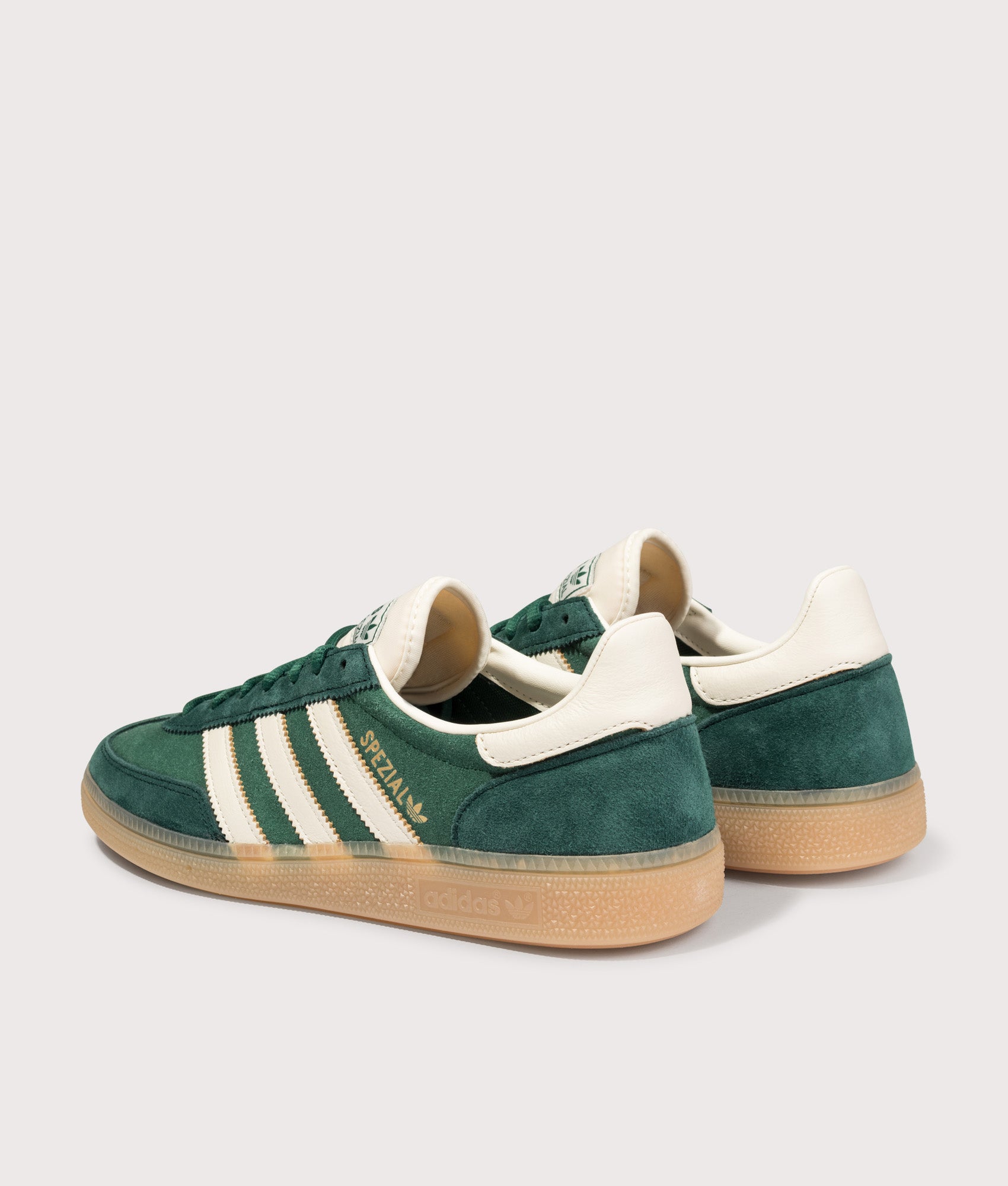 adidas Originals Handball Spezial Trainers in Collegiate Green/Off White/Aurora Ivy at EQVVS Menswear. Angled back shot.